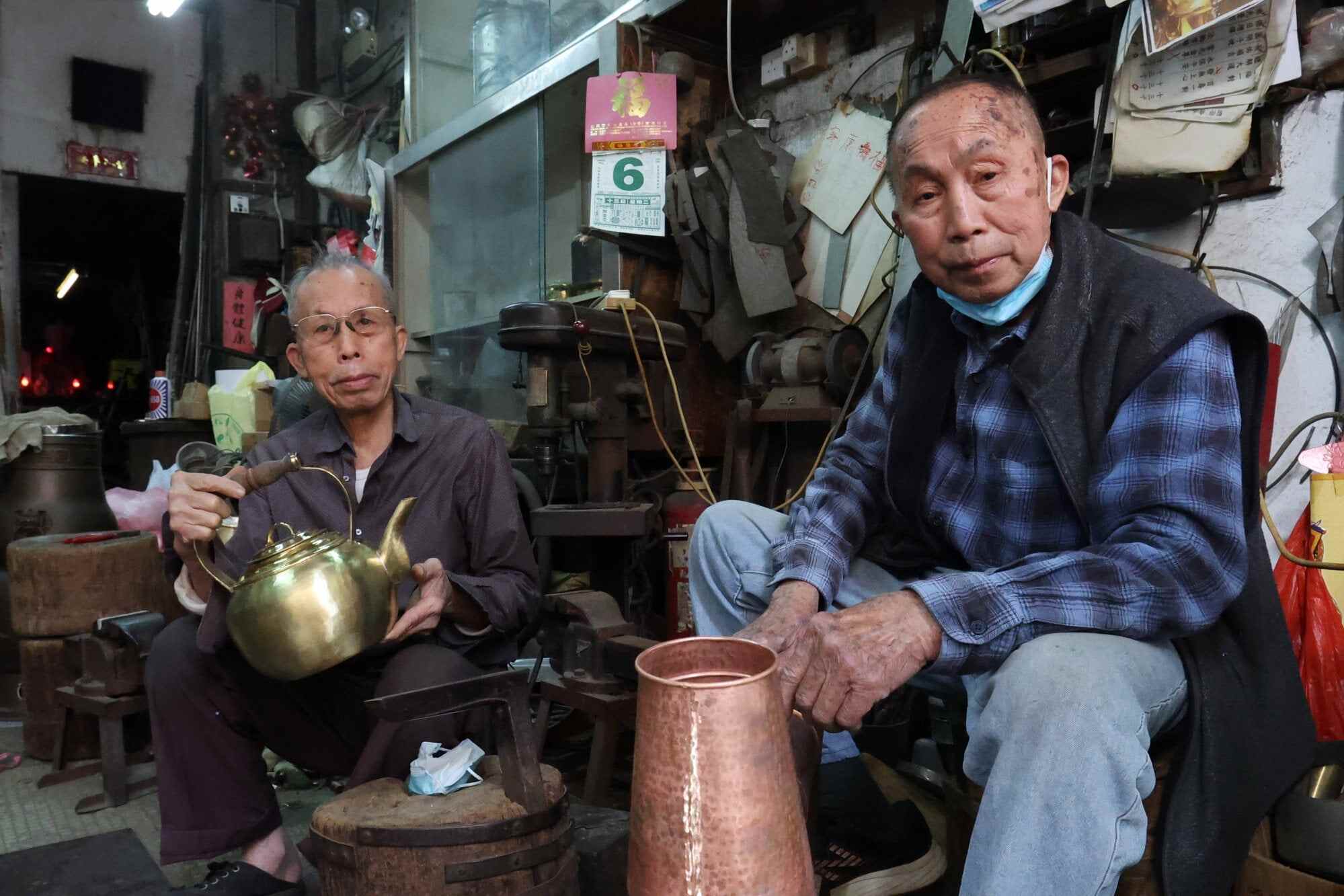 The owners of Ping Kee Copperware – two brothers, Luk Keung-choi (left) and Luk Shu-choi – have been hammering copper cookware for decades. Photo: Edmond So