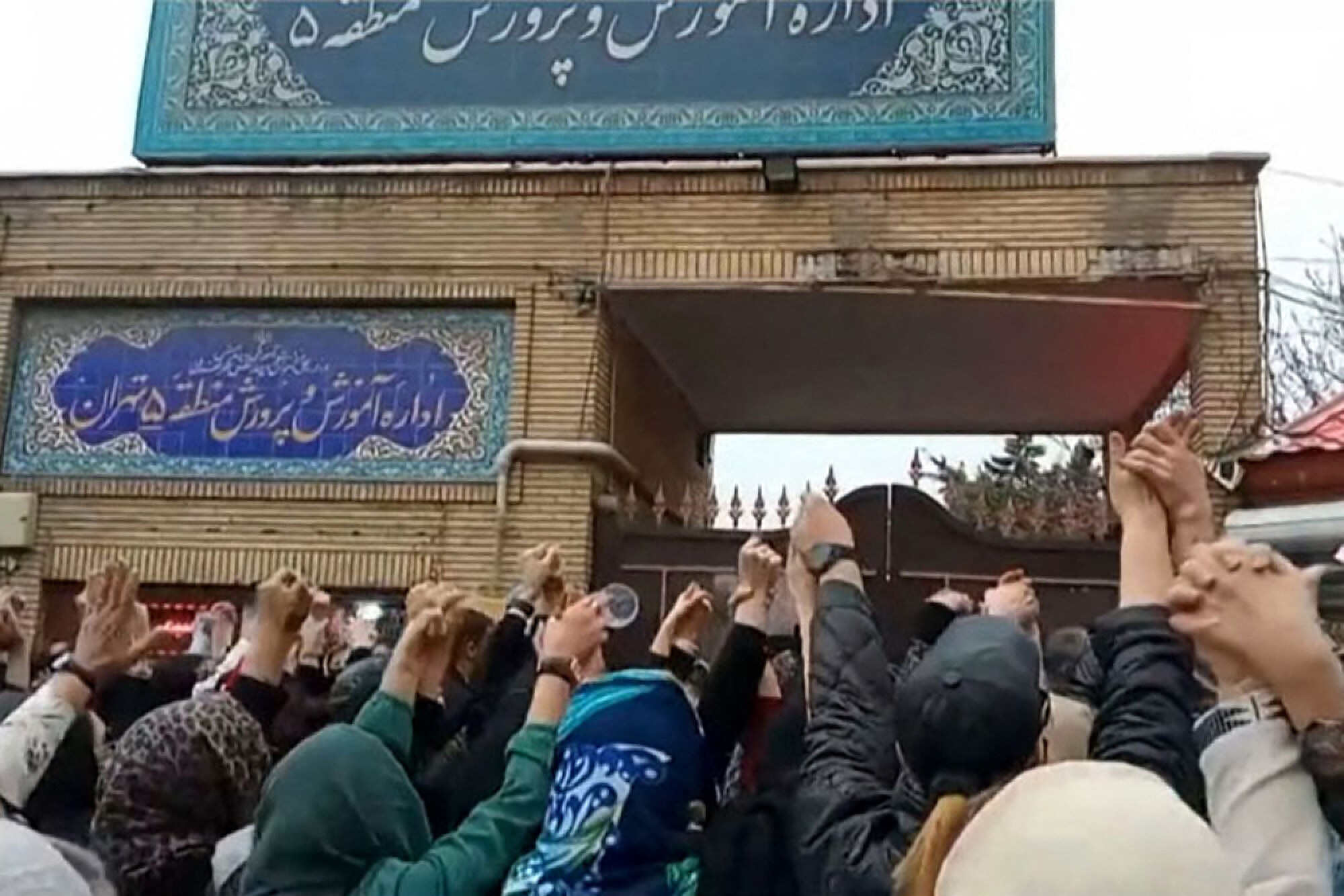 A grab taken from a UGC video made available on the ESN platform on March 4 shows families gathering and chanting slogans outside an education ministry building in Tehran, following poisoning attacks on students. Photo: AFP
