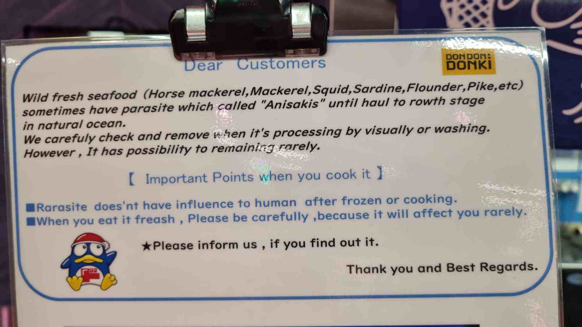 Signs at Don Don Donki in Singapore warn shoppers about the possibility of finding parasites in their fresh seafood. Photo: Lim Siewmei