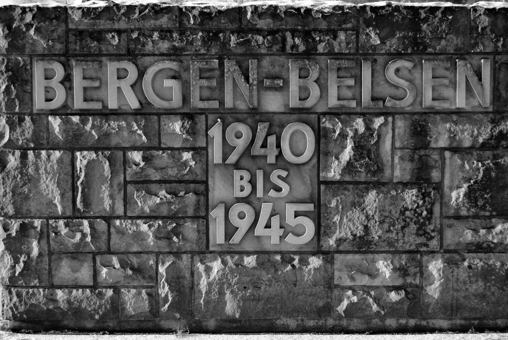 The stone wall at the entrance to the Bergen-Belsen concentration camp with the dates when it was in use. Photo: Shutterstock