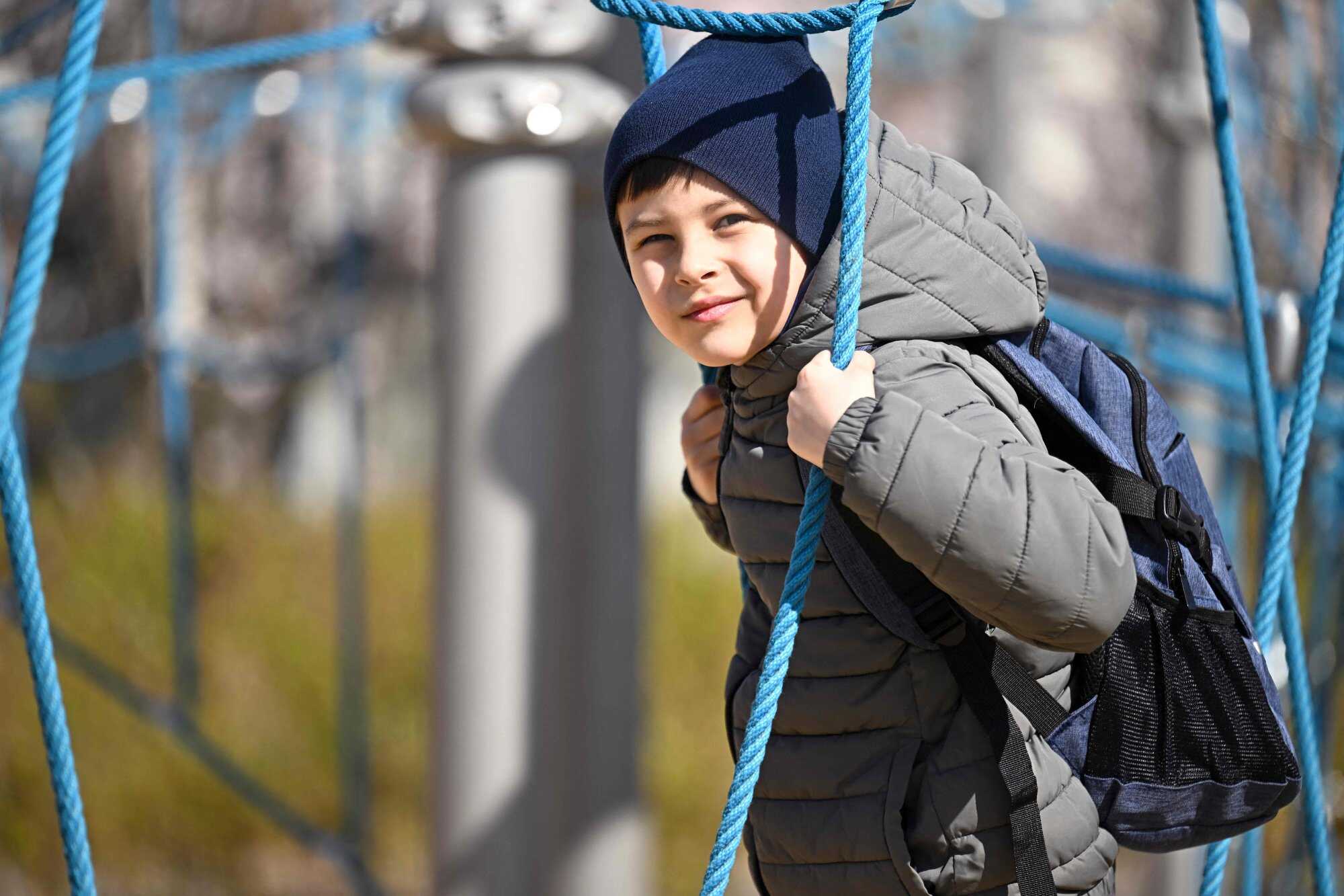 Ukrainian refugee Roman, who has autism, looks at the camera as he plays near his temporary home in Budapest, Hungary. Photo: AFP