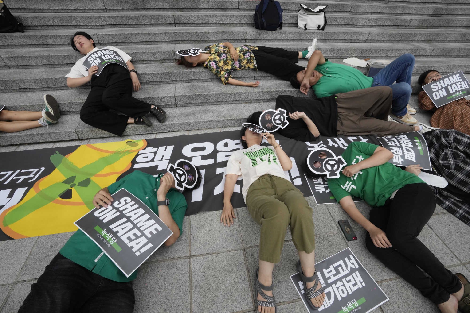 Environmental activists stage a die-in during a rally in Seoul, South Korea against the Japanese government’s decision to discharge treated radioactive water from the Fukushima plant into the ocean. Photo: AP