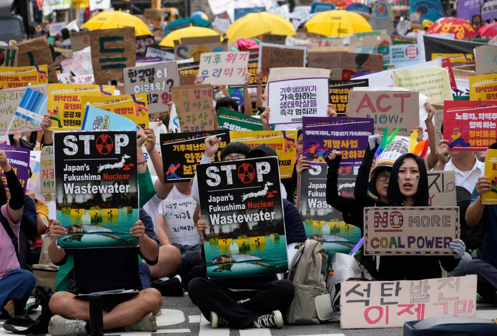 Activists holding posters against the Fukushima power plant’s waste water release join a rally and shout slogans demanding actions to stop the climate crisis, in Seoul, South Korea, on September 23. Photo: AP