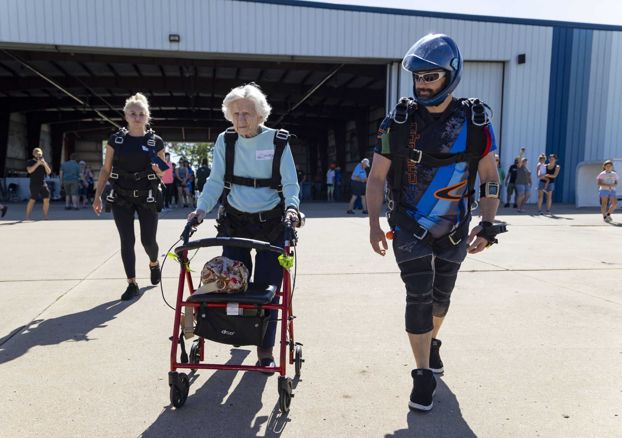 Dorothy Hoffner, 104, walks out to the plane with tandem jumper. Photo: AP