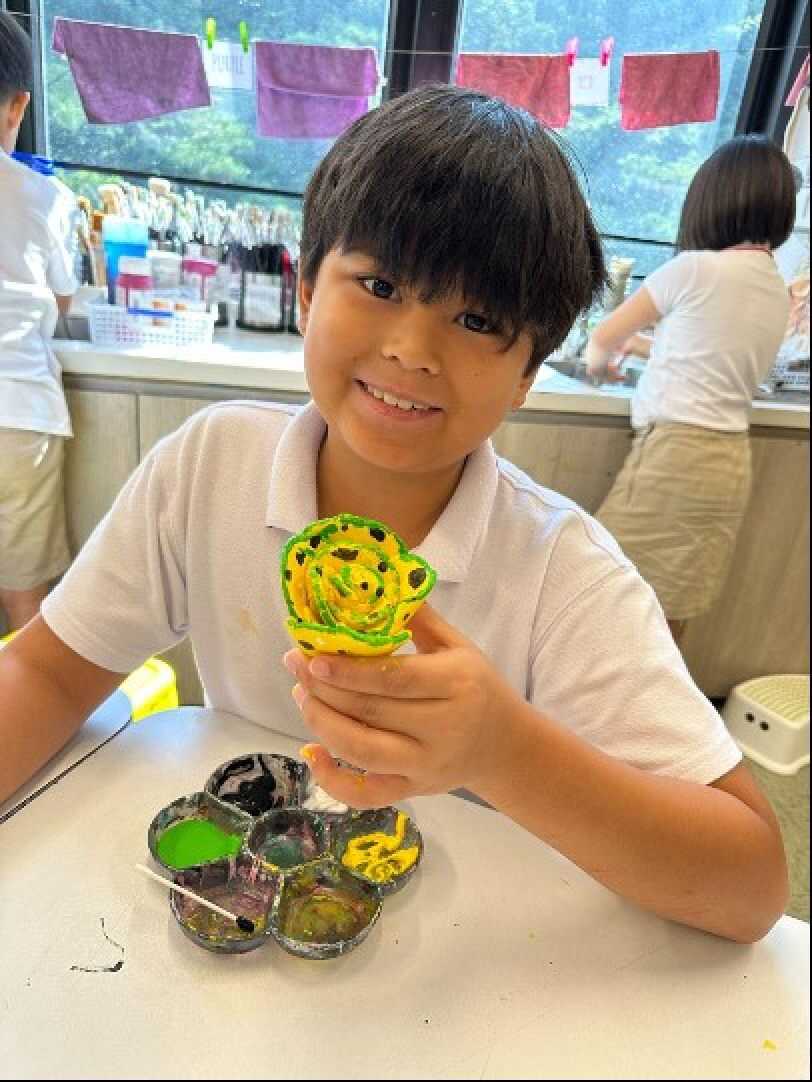 Lincoln holds the clay flower he has made. Photo: Handout