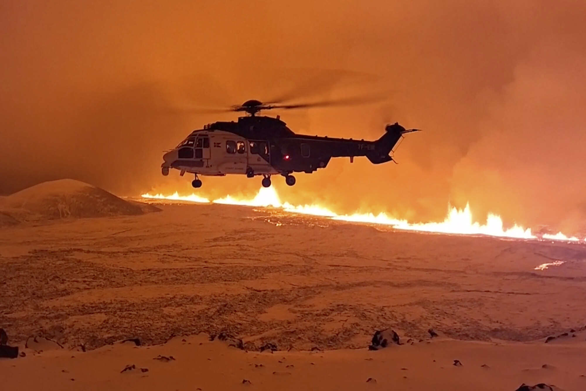 An Icelandic coastguard helicopter seen after a volcanic eruption started Monday night on the Reykjanes peninsula, prompting the country’s civil defence to be on high alert. Photo: AP