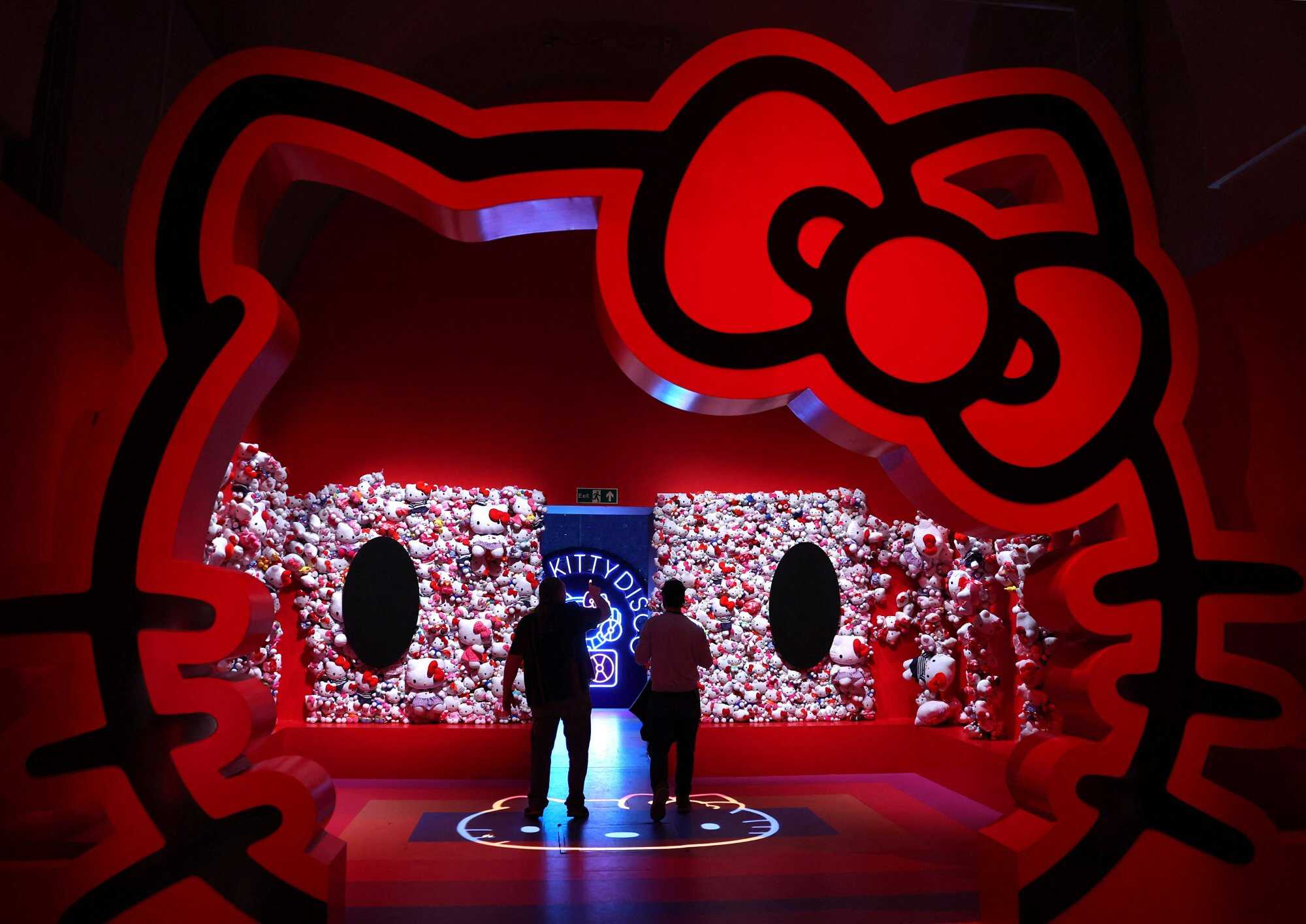 Employees inspect an installation that forms part of an exhibition exploring the idea of cuteness in modern culture. Photo: Reuters