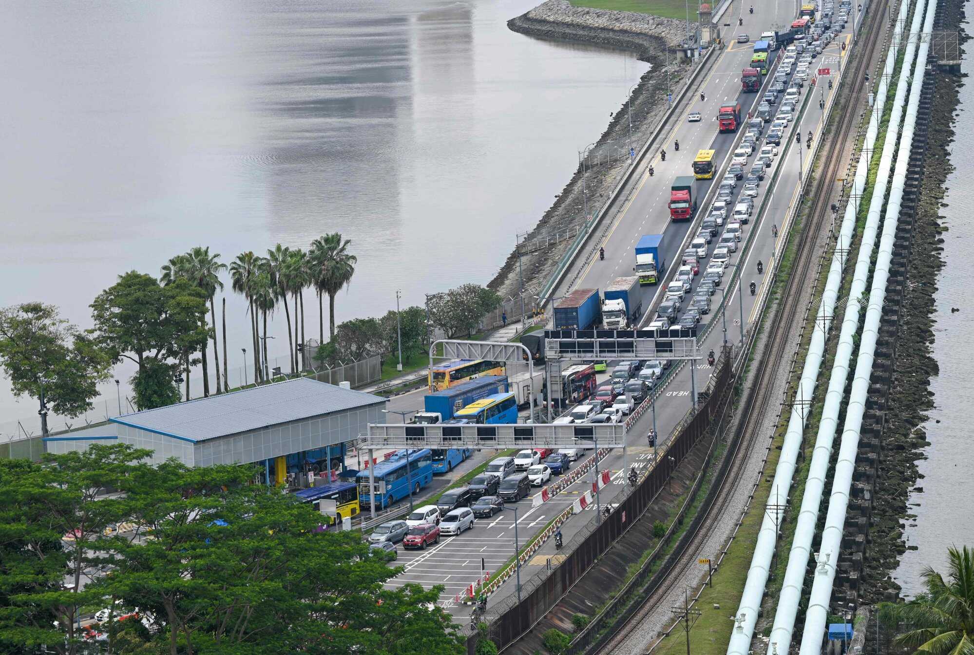 Travellers can show a QR code instead of passports when entering Singapore by car. Photo: AFP