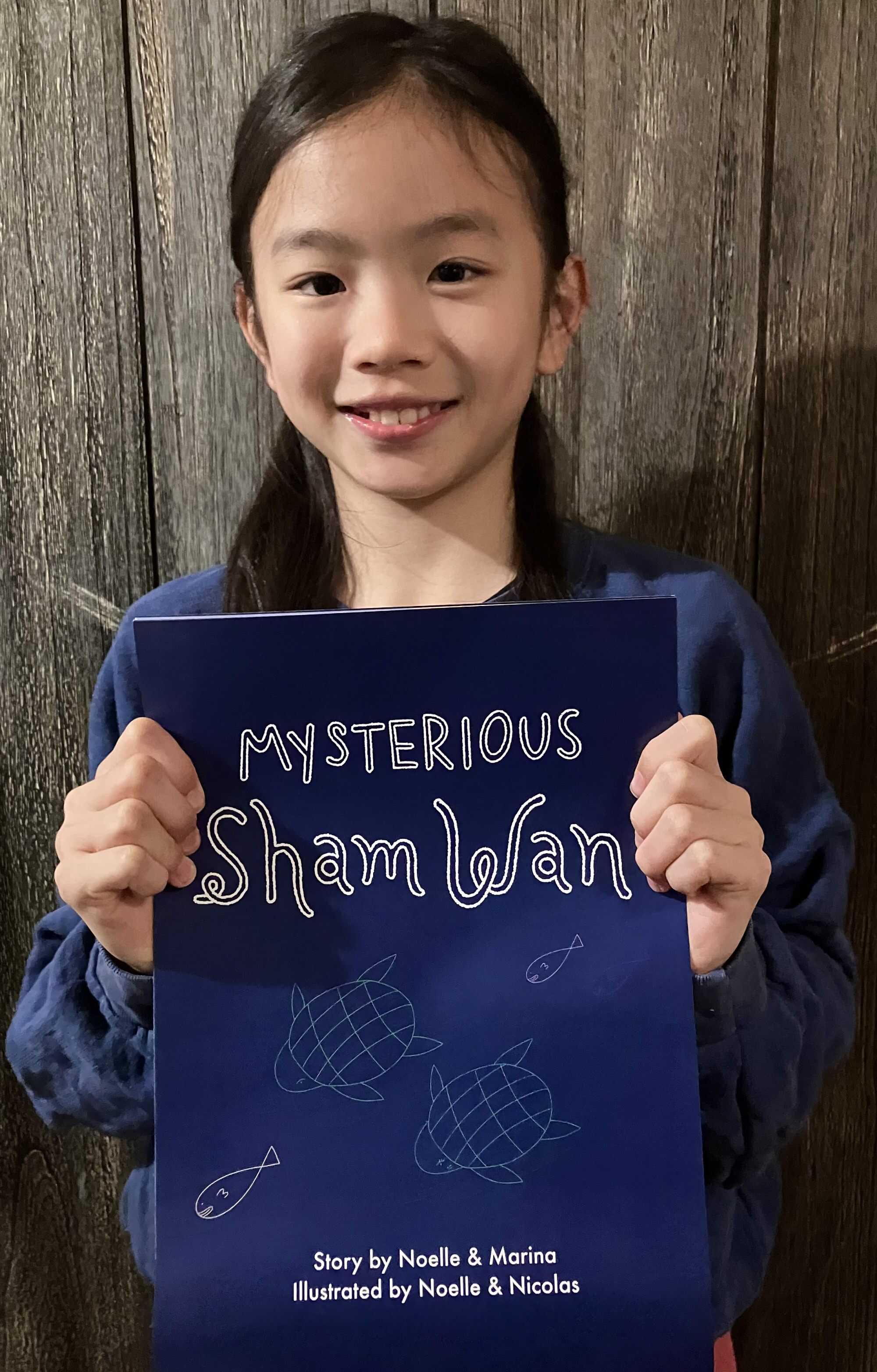 Noelle poses with her book “Mysterious Sham Wan”. Photo: Handout