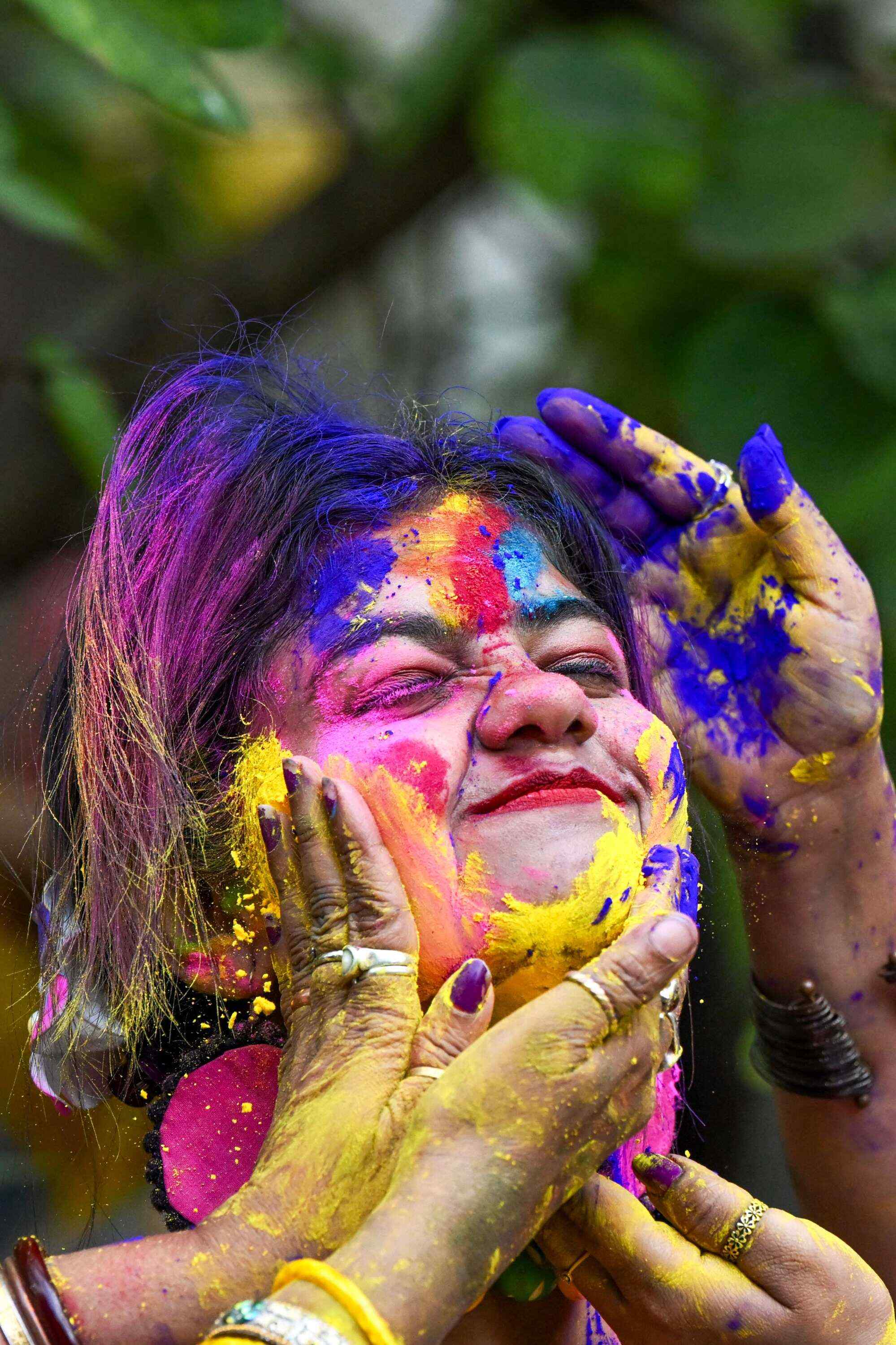 A woman is smeared with colourful powder as she celebrates Holi, the Hindu spring festival of colours, in the city of Kolkata. Photo: AFP