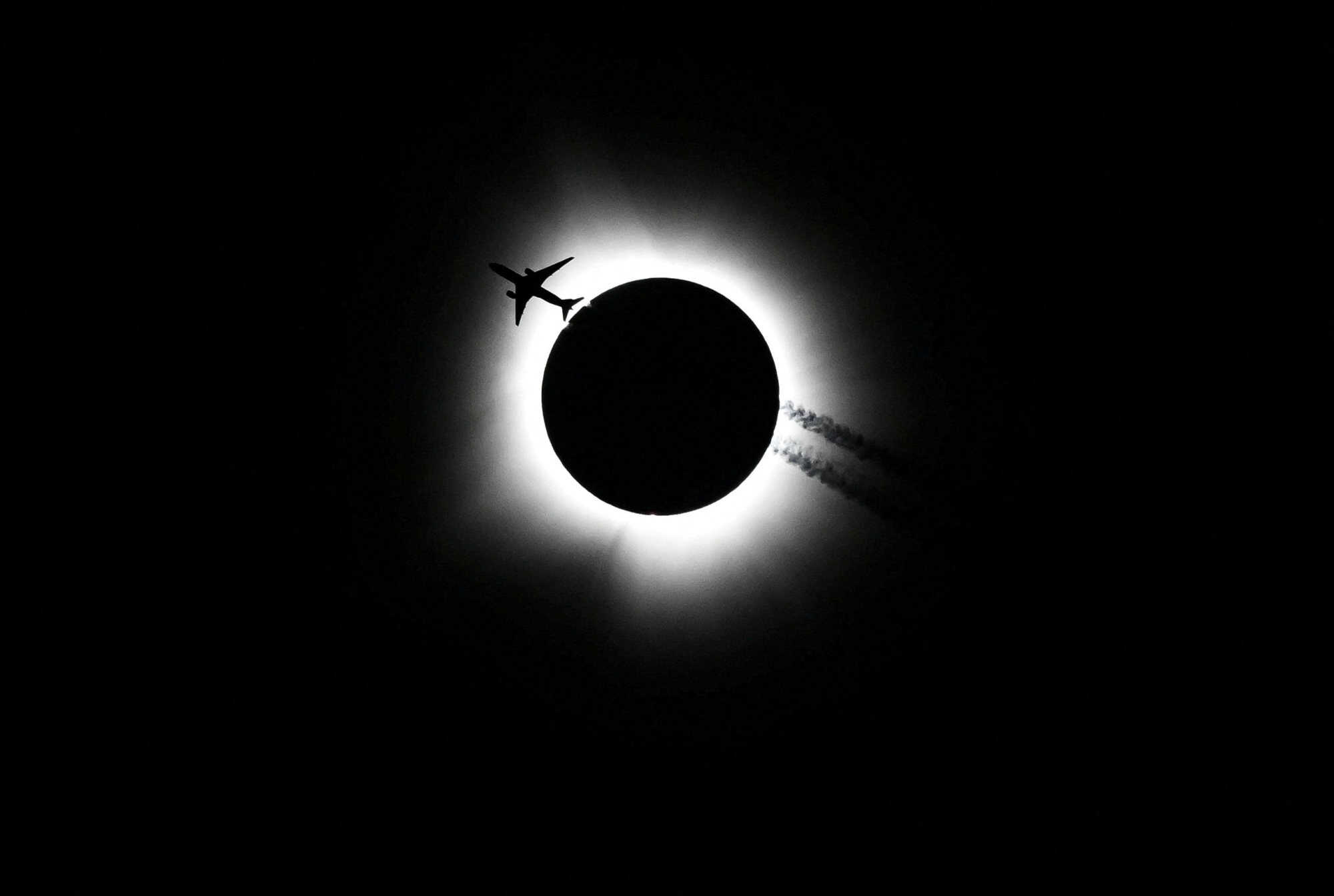An airplane passes near the total solar eclipse in Bloomington, Indiana, US. Photo: USA Today Network via Reuters