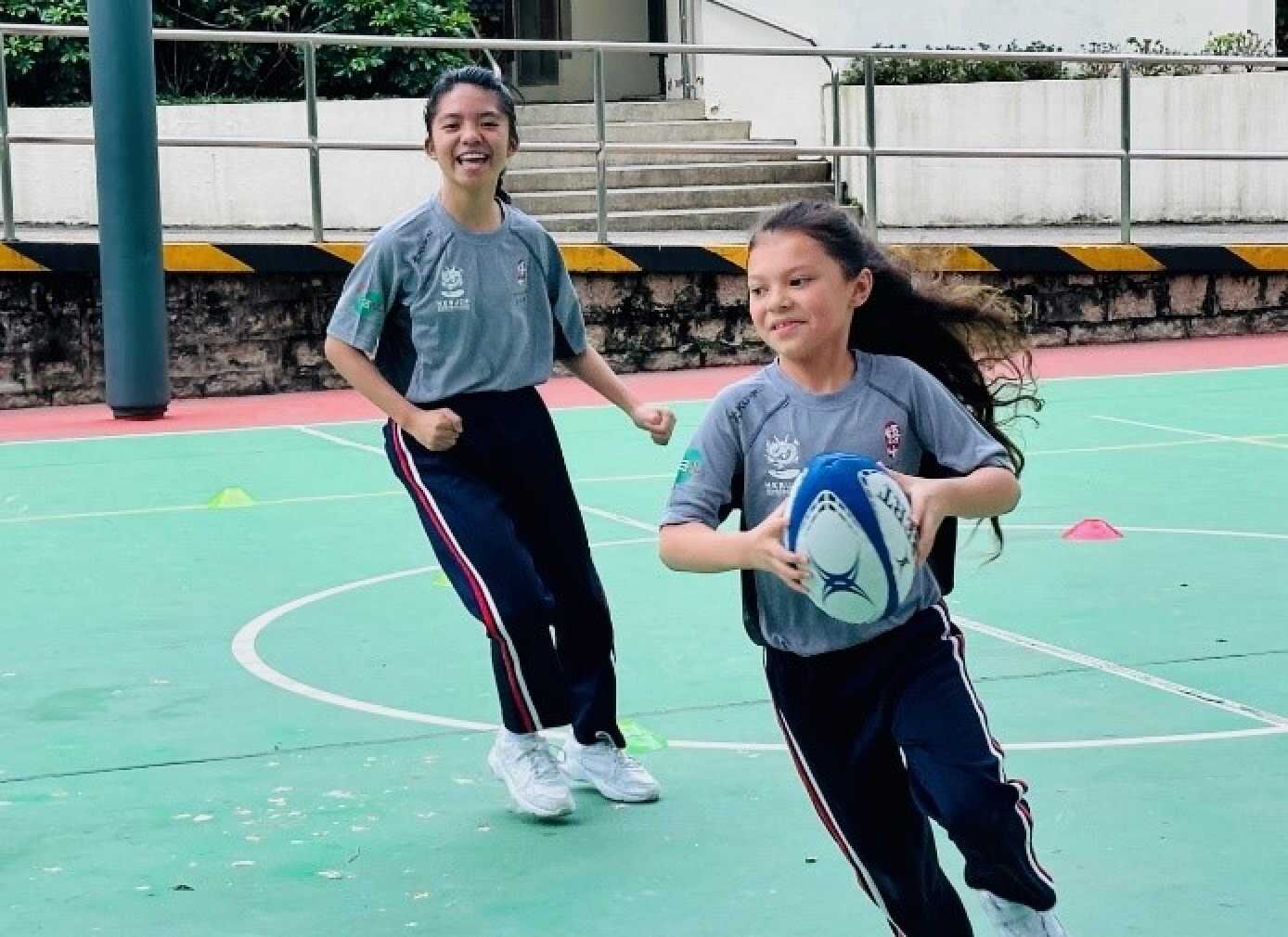 Gabriella (left) has learned a lot from rugby. Photo: Handout