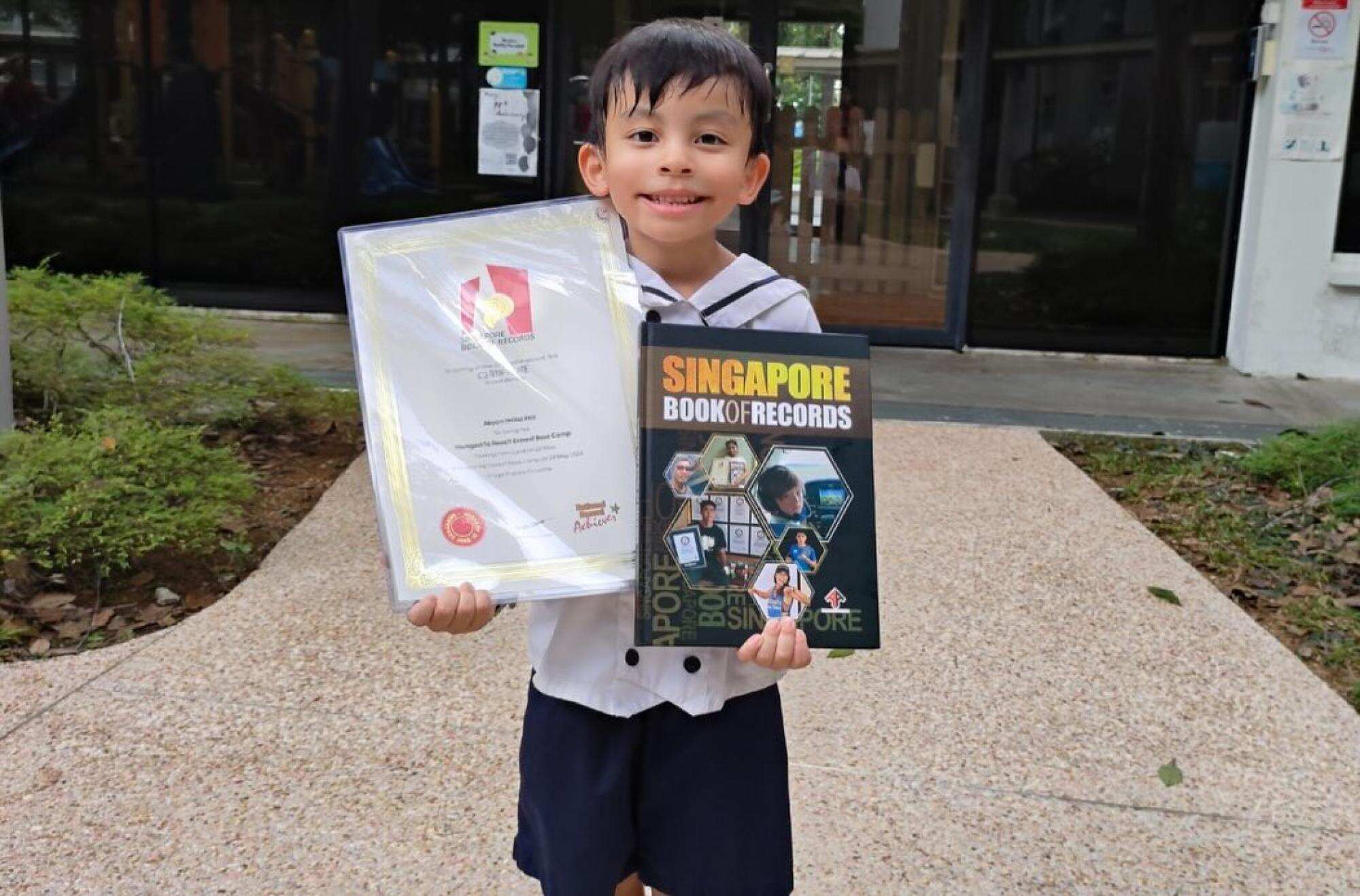 Abyan has received an award from Ong Eng Huat, the president of the Singapore Book of Records for being the “Youngest Singaporean to Reach Everest Base Camp”. Photo: Handout