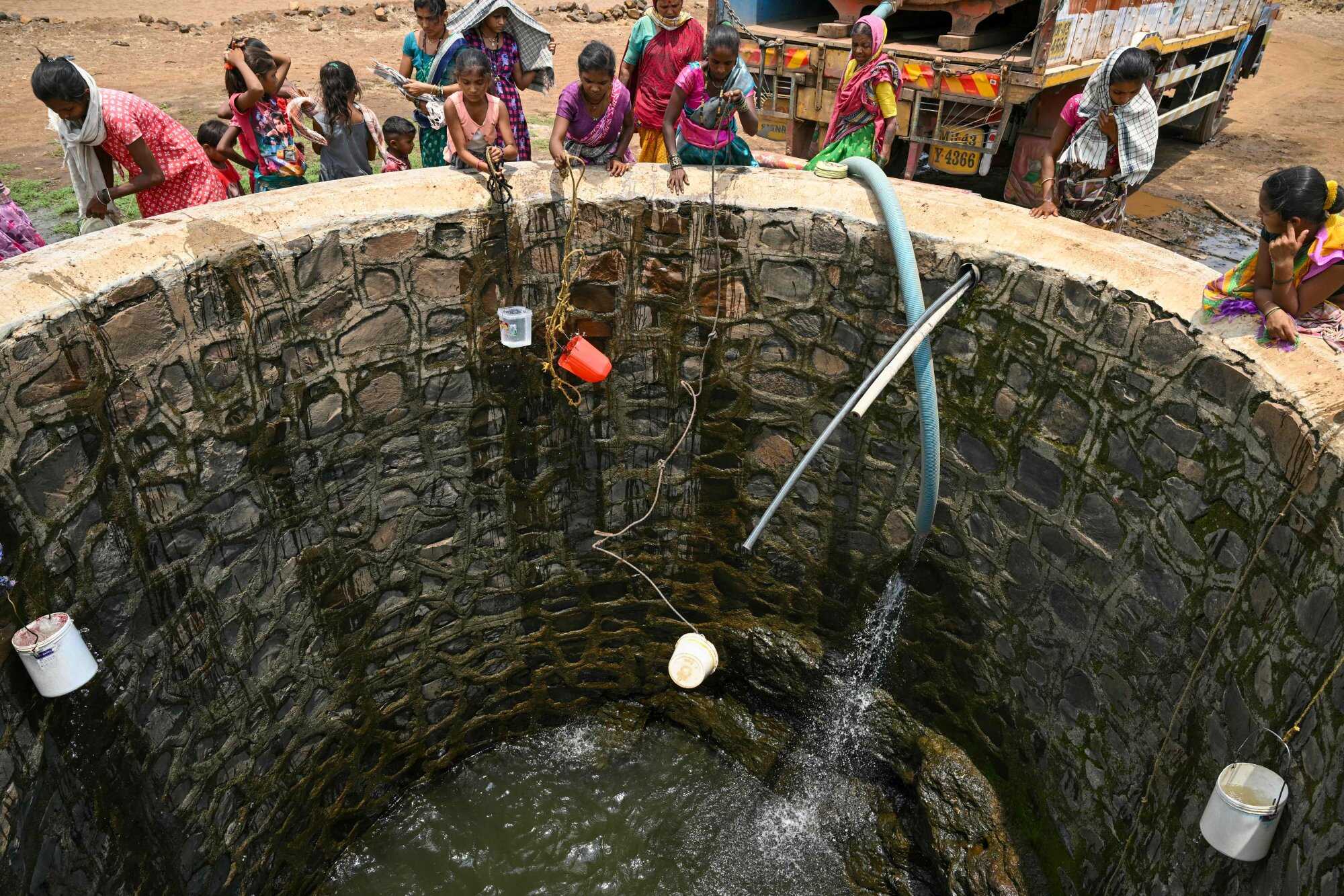 Villagers fill water from a well in Shahapur district of India’s Maharashtra state, amid a heatwave. Photo: AFP