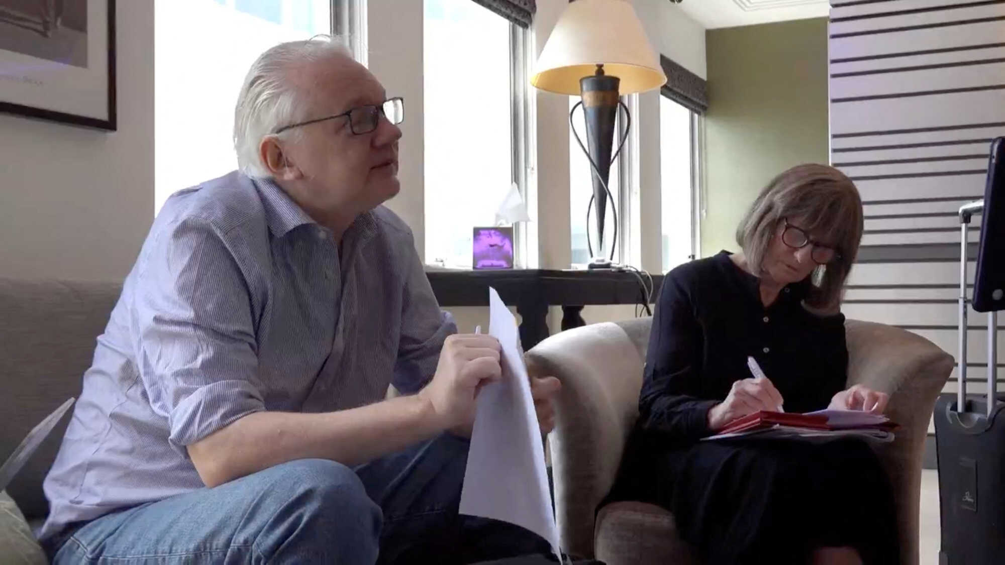 WikiLeaks founder Julian Assange holds a document at a location given as London, Britain, in this still image from video released earlier today. Photo: Reuters