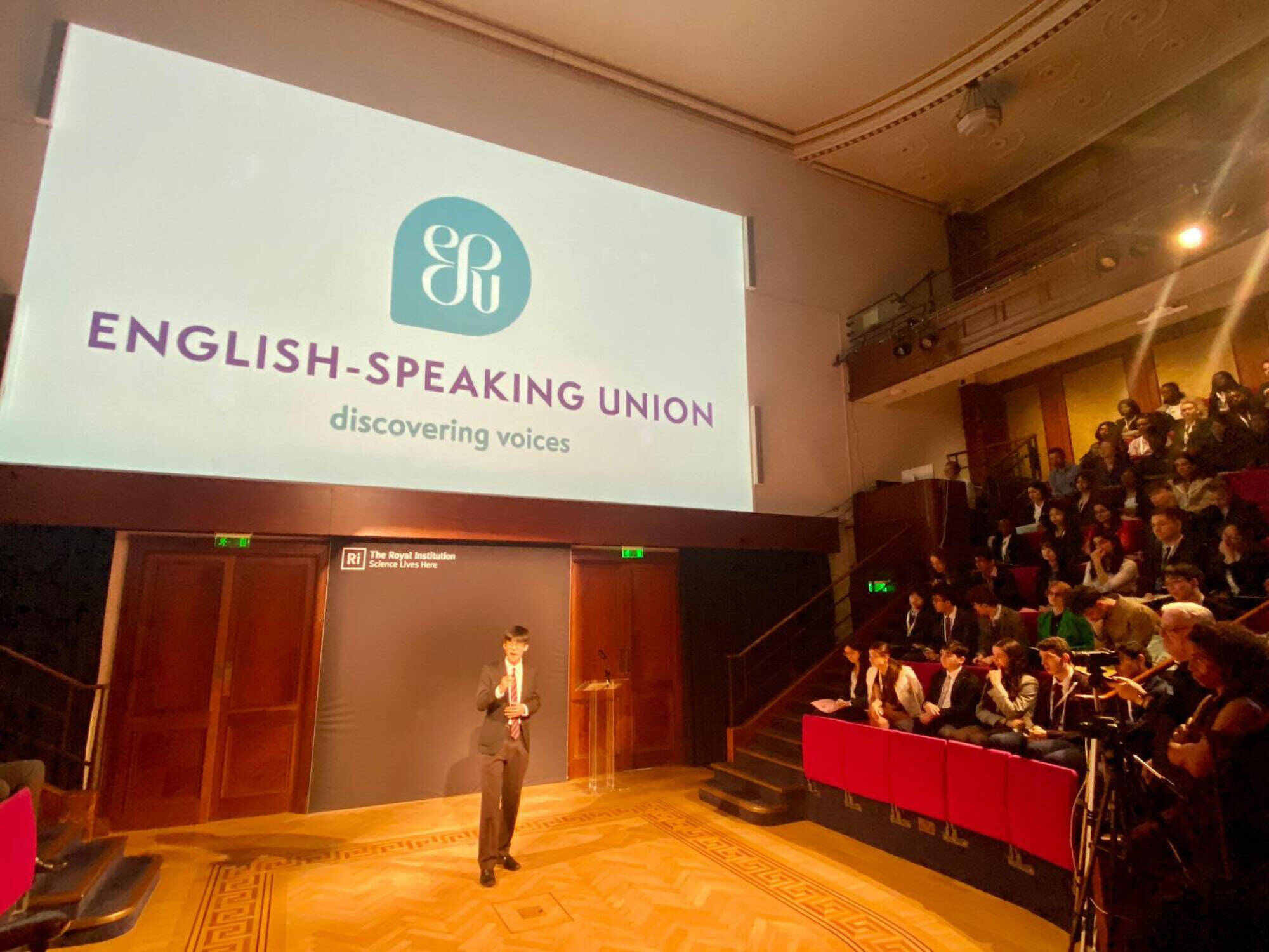 Benjamin gives his speech at the grand final in London. Photo: Handout