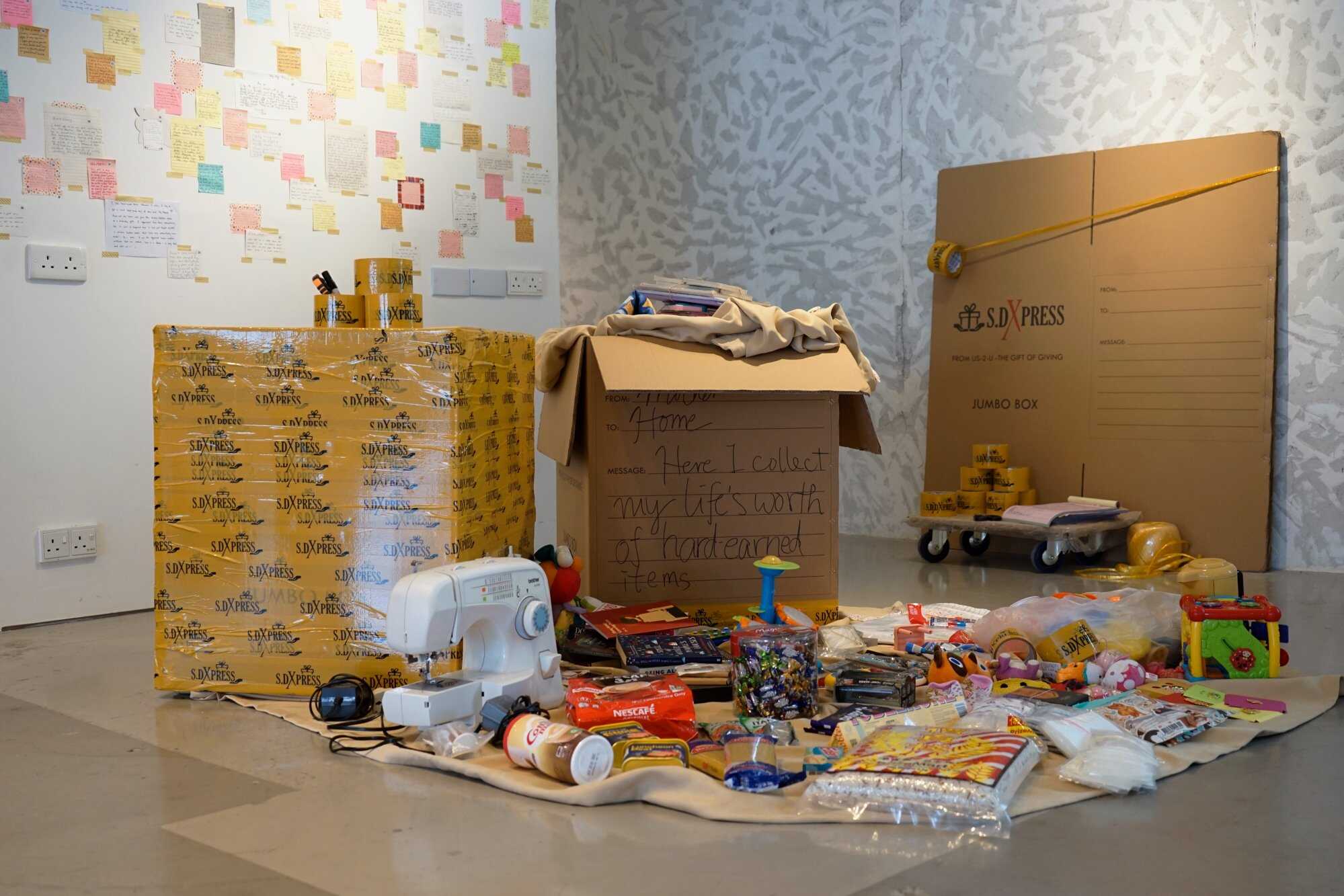 Artists Sharu Binnong Sikdar and Dhafney Dela Cruz Pineda created a piece featuring balikbayan boxes, which are large packages that the Filipino diaspora fills up with gifts, hand-me-downs, and essentials for loved ones back home. Photo: Handout