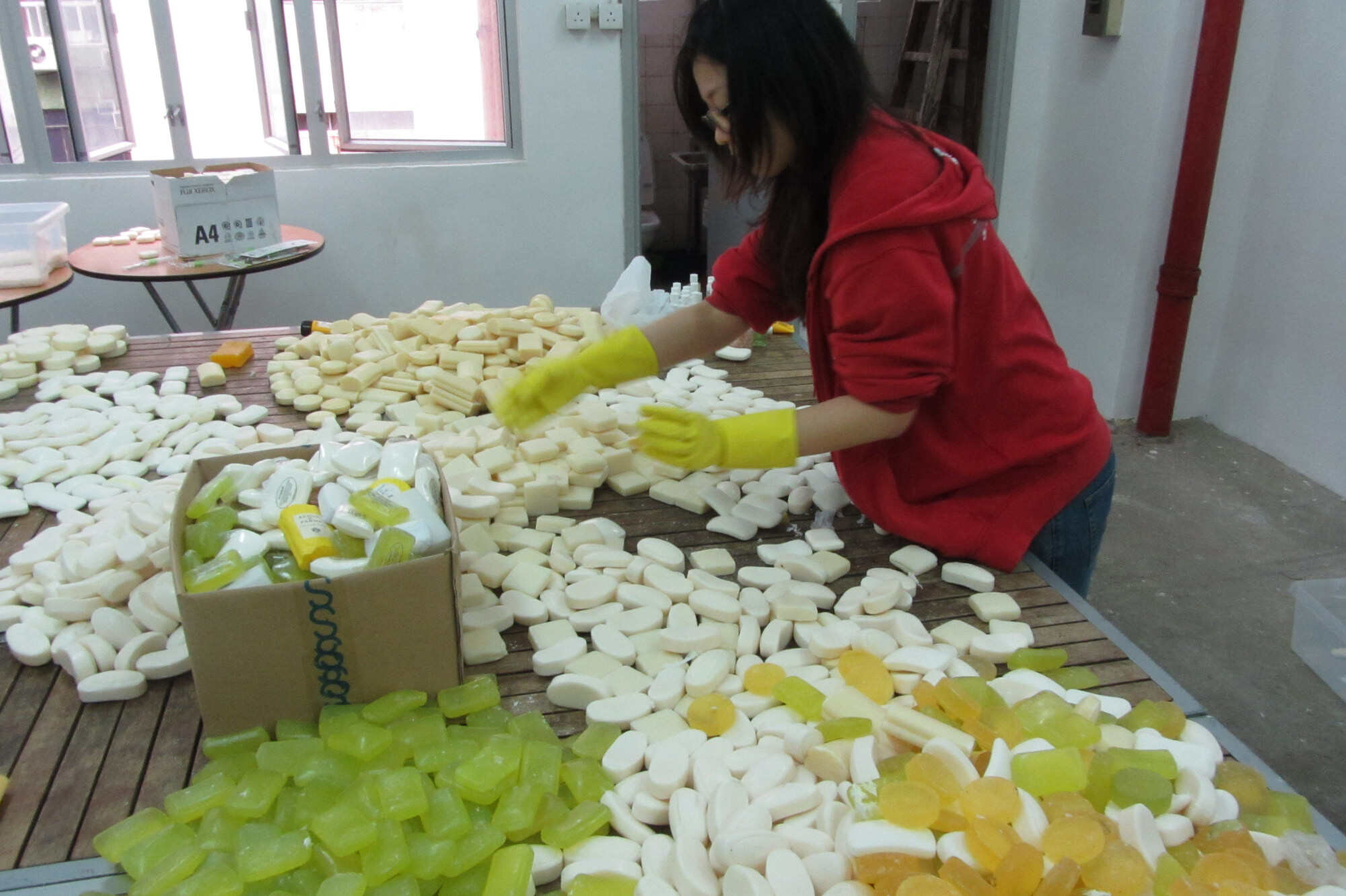 A volunteer helps to sort out bars of soap collected from various Hong Kong hotels. Photo: Handout
