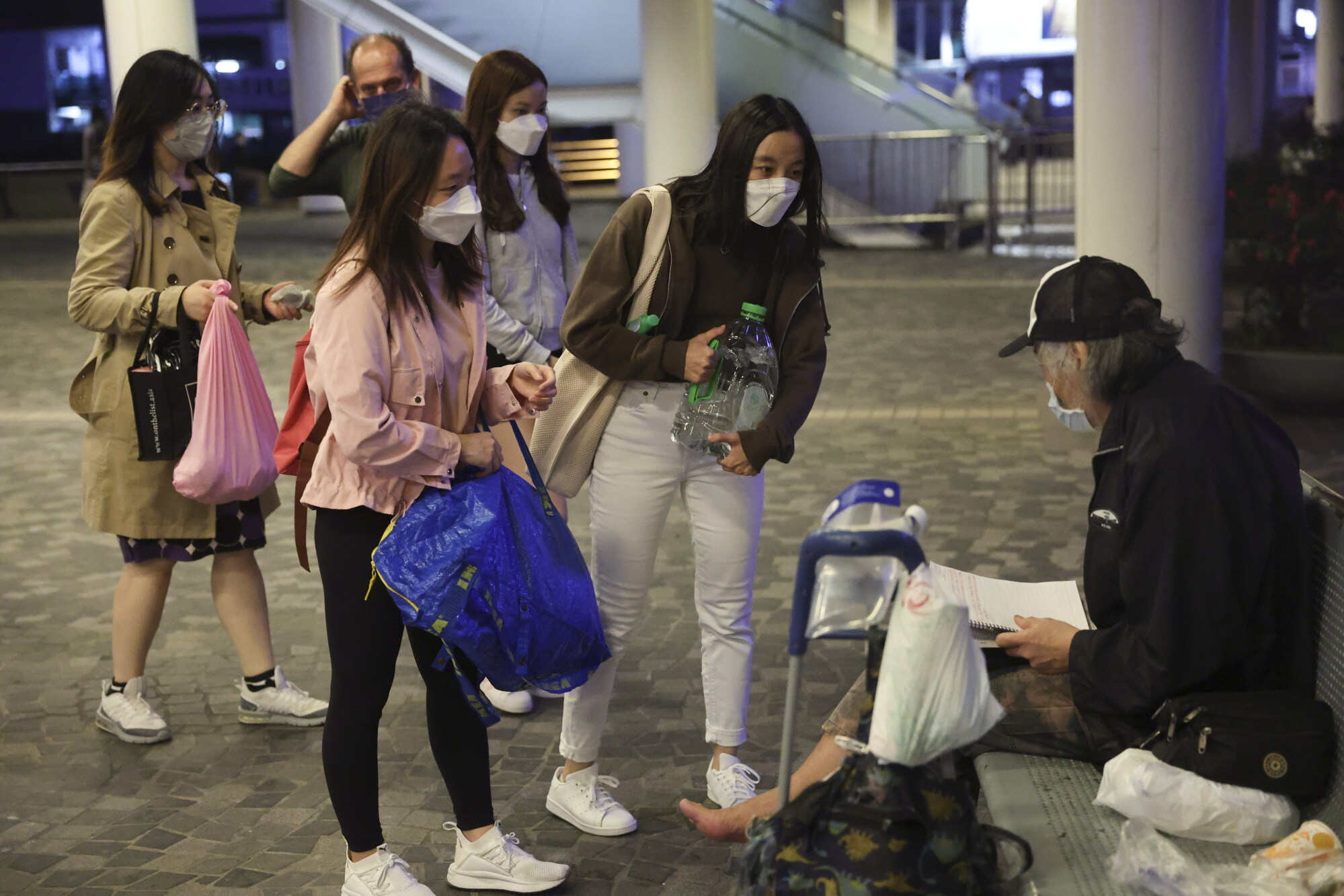 Kindness Walks’ volunteers distribute practical items to homeless people in Tsim Sha Tsui. Photo: Edmond So