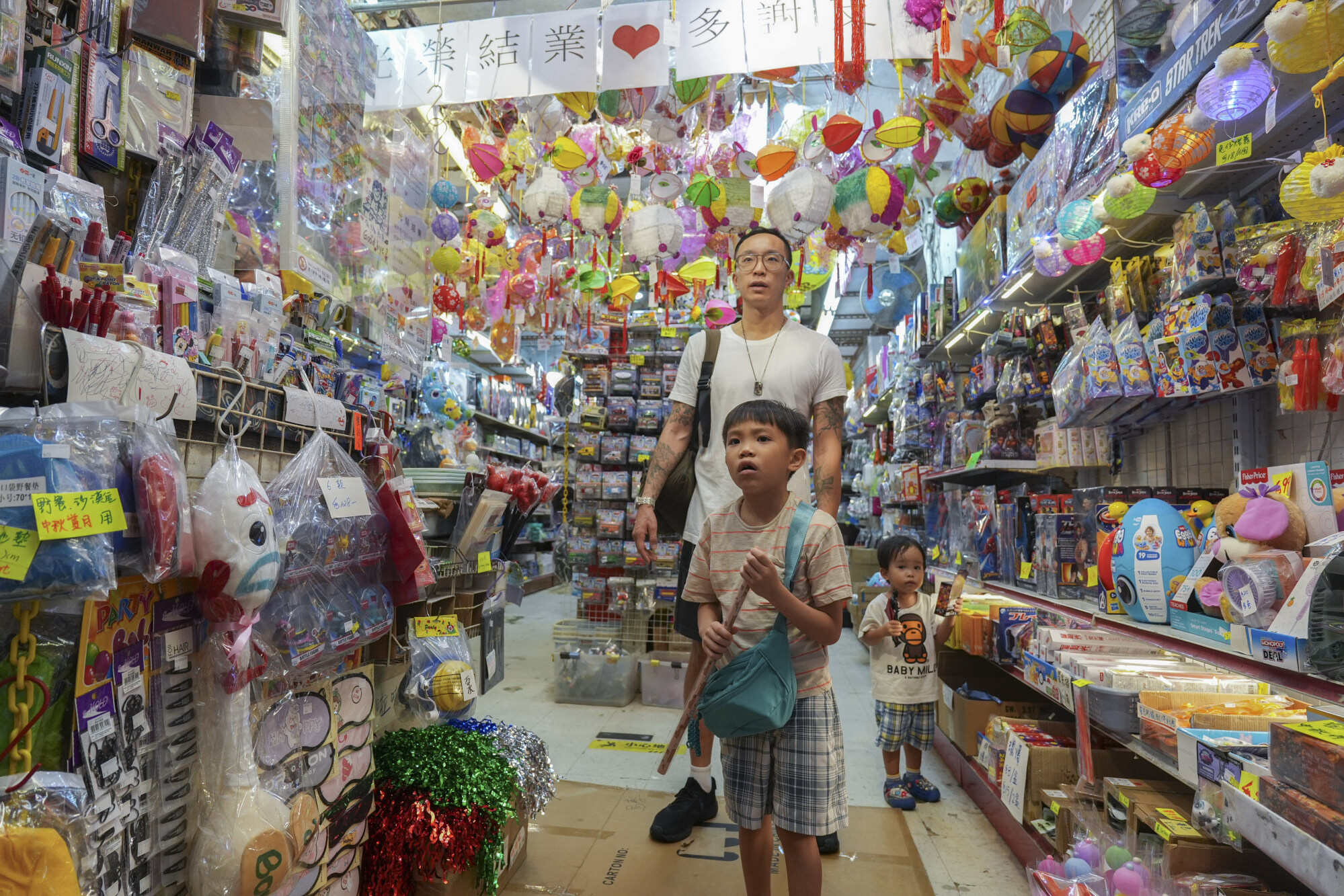 Children make their selection of toys at the store as business winds down. Photo: Eugene Lee