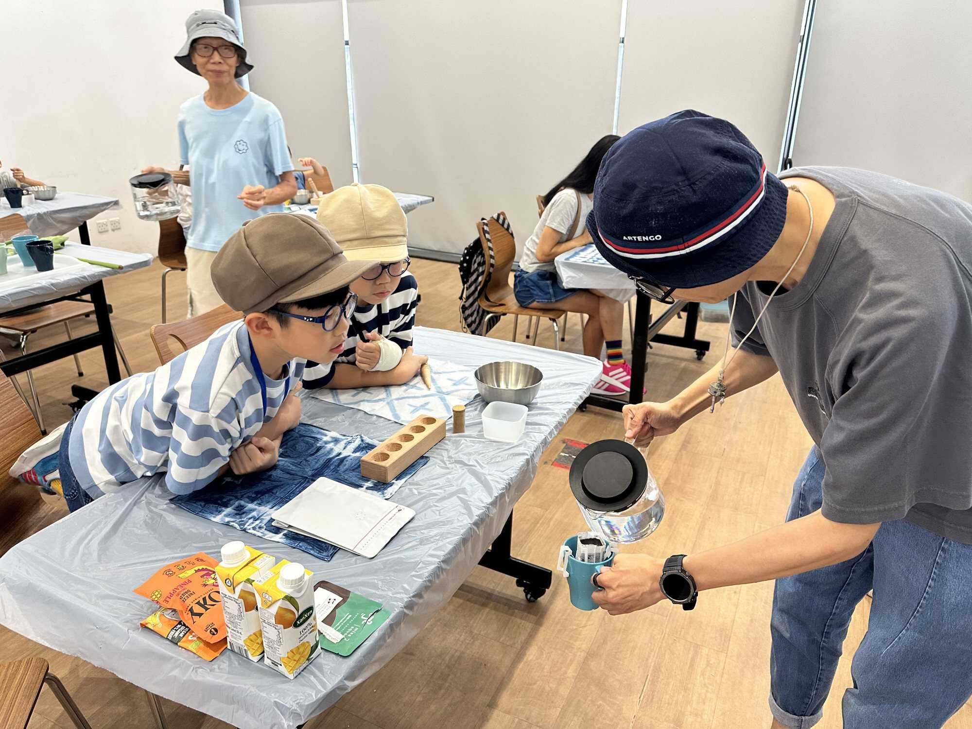 Skyler and Thyler Ng participate in a coffee ground upcycling workshop. Photo: Handout