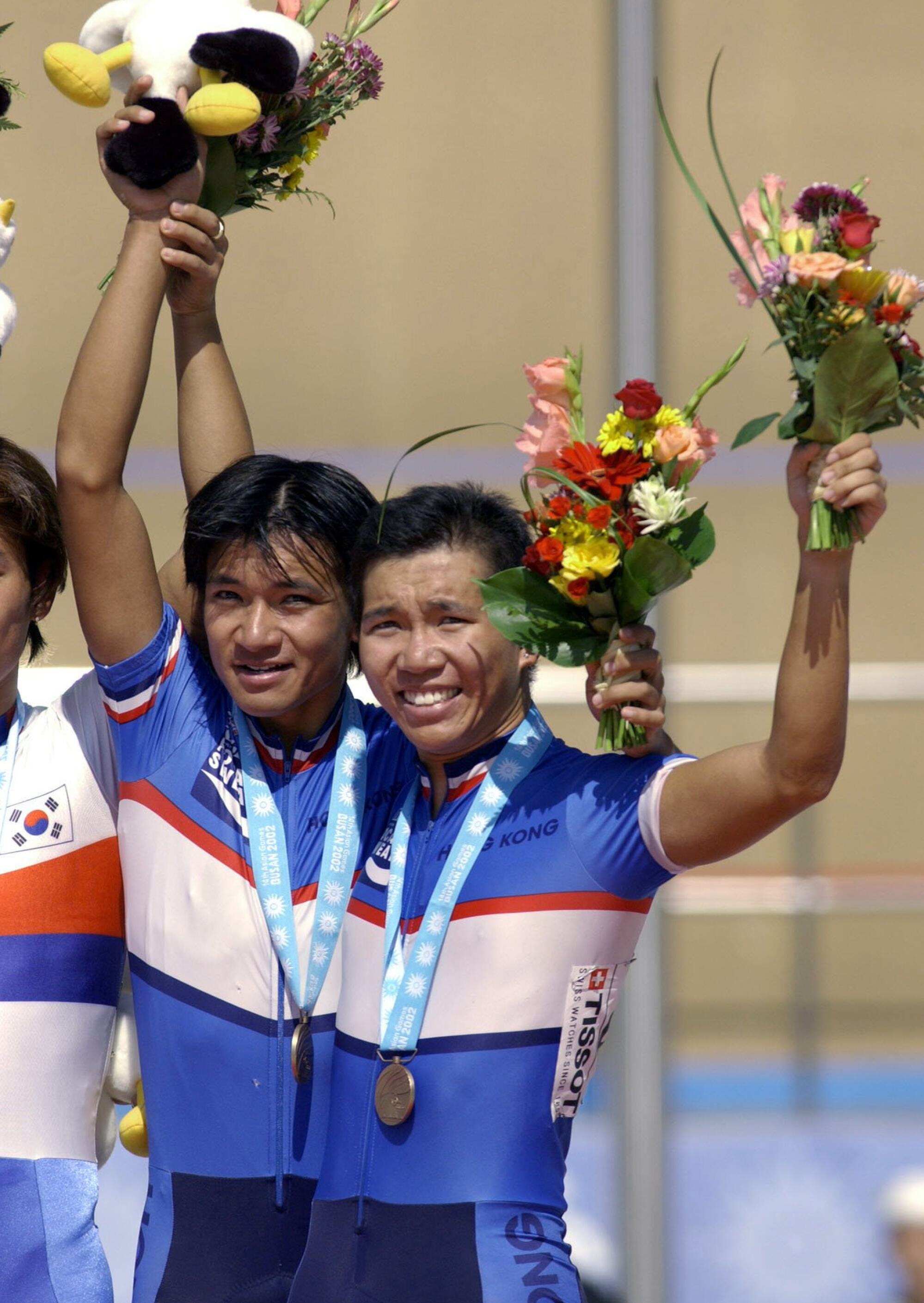 Hong Kong cycling team members Alan Ho Siu-lun (right) and Wong Kam-po after winning third place in the 2002 Asian Games Men’s Madison final in Busan, South Korea. Photo: Antony Dickson