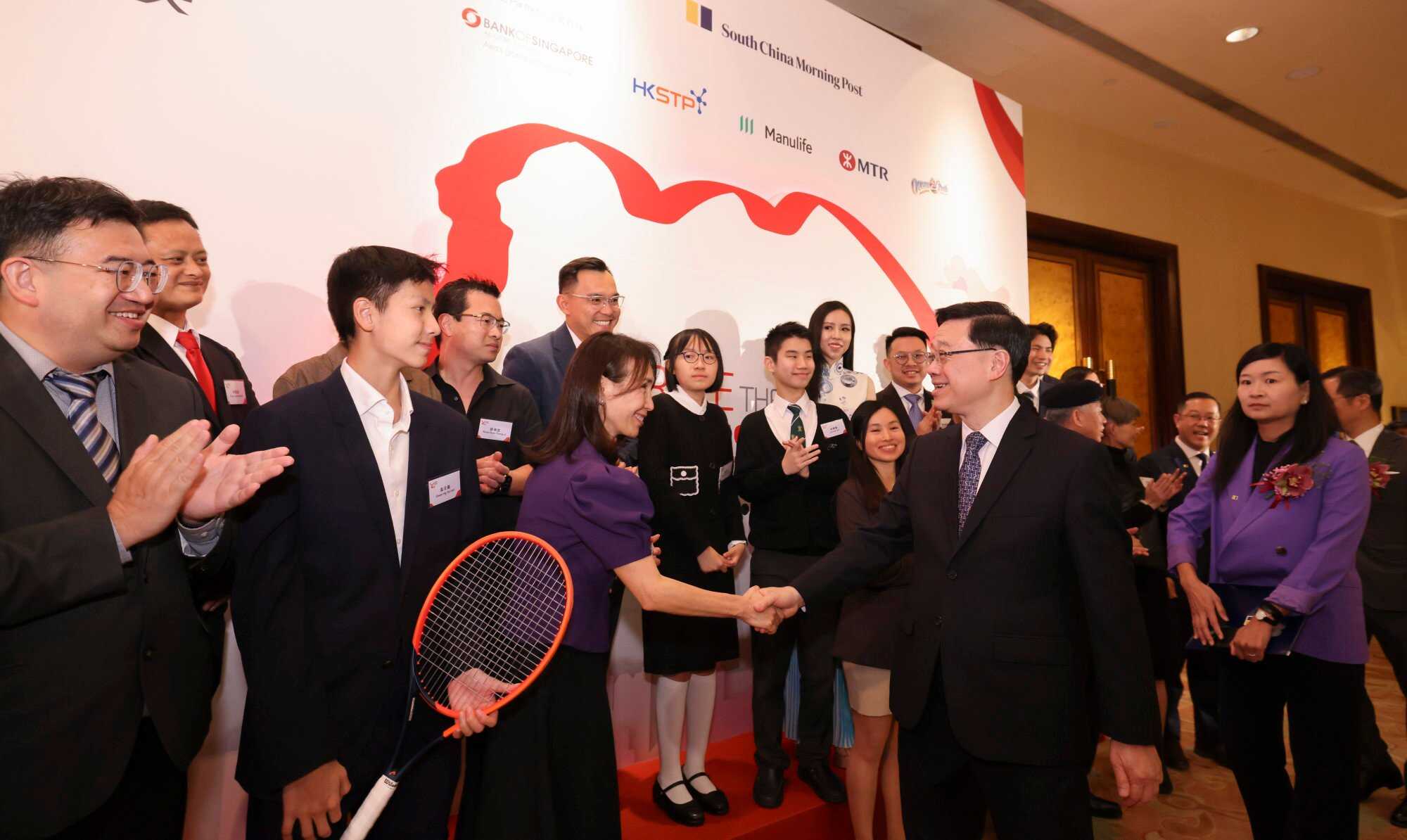 Chief Executive John Lee Ka-chiu and Chief Executive Officer of the South China Morning Post Catherine So greet finalists at the 12th Spirit of Hong Kong Awards. Photo: Nora Tam