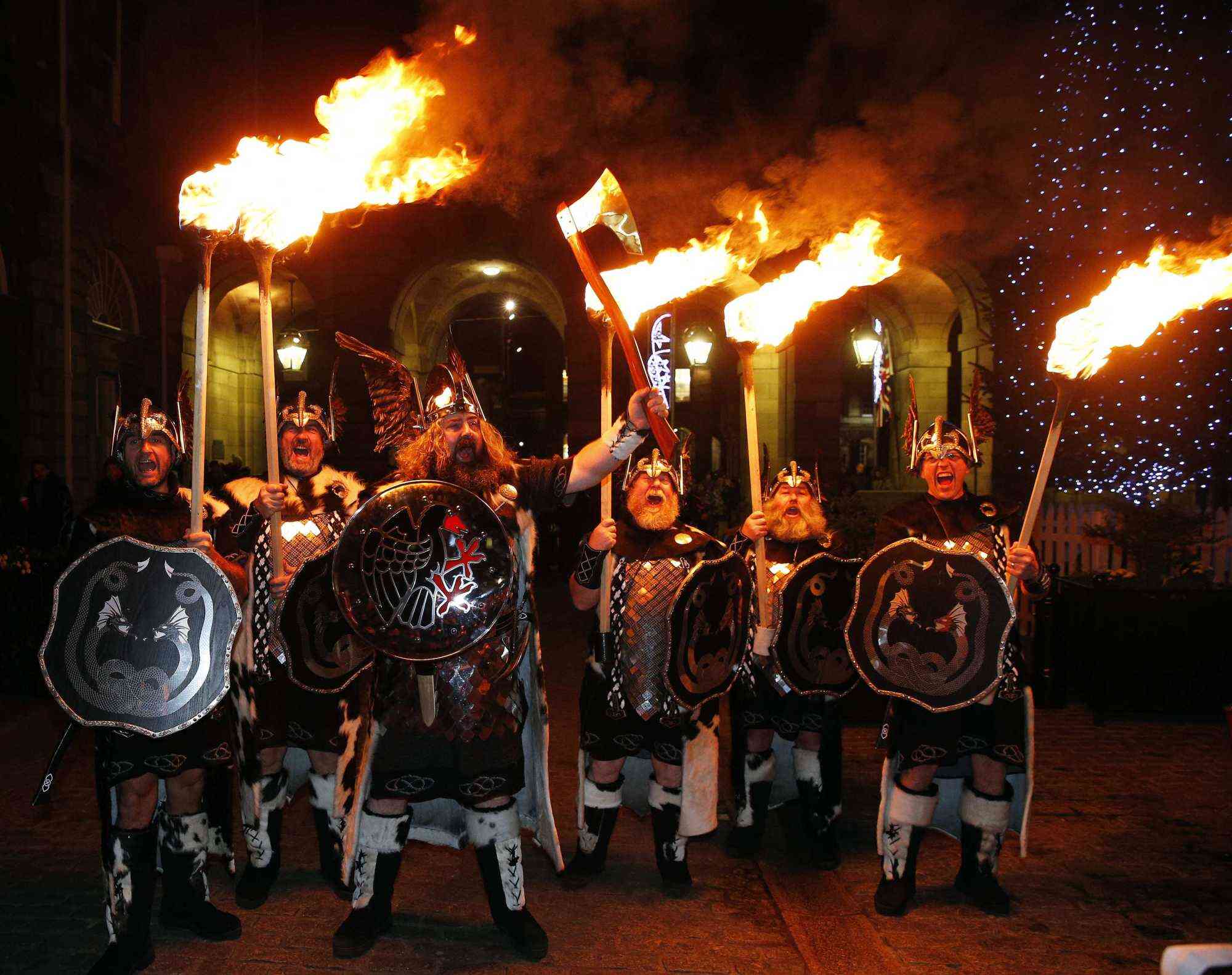 People hold lit torches during the annual procession to mark the start of Hogmanay celebrations in Edinburgh, Scotland. Photo: Reuters