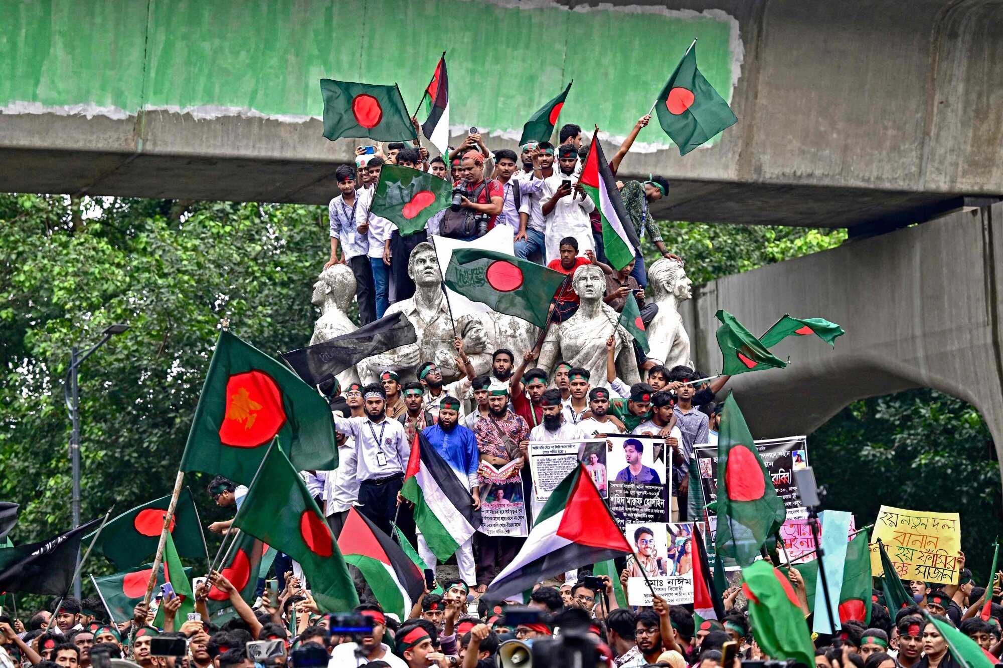 Demonstrators wave Bangladesh’s national flag during the Martyr March, a rally organised by Students Against Discrimination to mark one month since the ousting of the country’s former prime minister, Sheikh Hasina. Photo: AFP