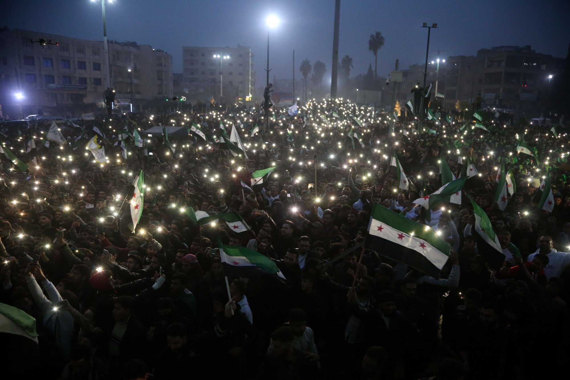 People wave Syrian Opposition flags as they take part in a ‘Liberation Festival’ to celebrate the ouster of Syrian president Bashar Al-Assad in Idlib, northwestern Syria. Photo: EPA-EFE