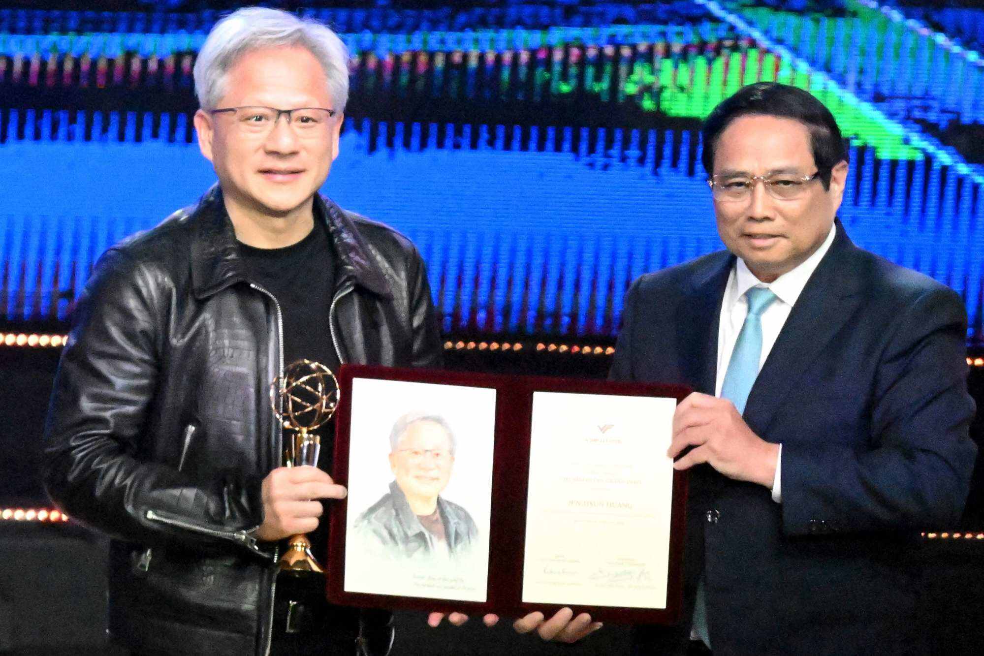 Nvidia’s CEO and founder Jensen Huang (left) receives the Vinfuture Prize from Vietnams prime minister Pham Minh Chinh in Hanoi on December 6, 2024. Photo: AFP