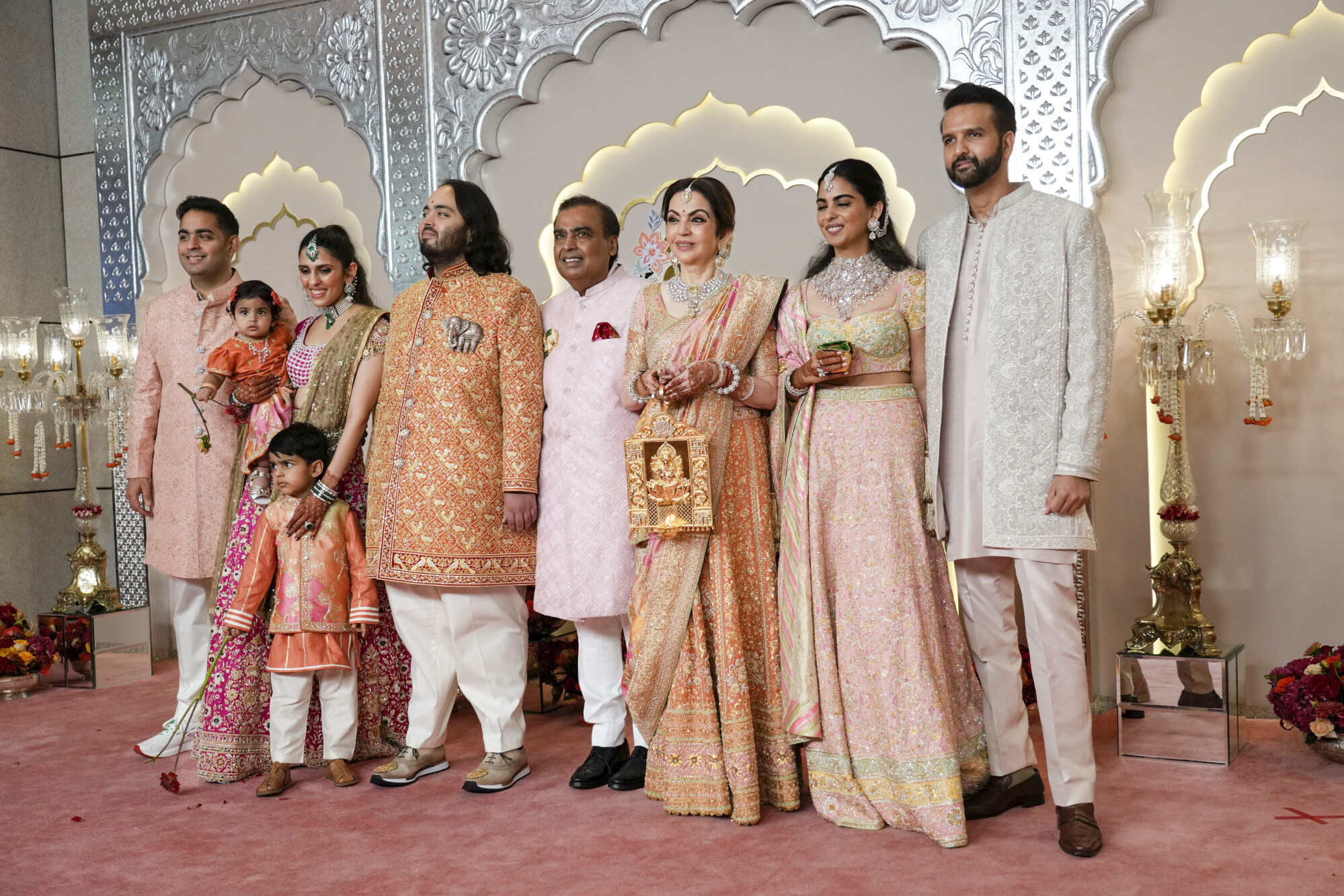 Billionaire Mukesh Ambani (centre) poses for a photograph with his family at the wedding of his son Anant Ambani and Radhika Merchant in Mumbai, India. Photo: AP