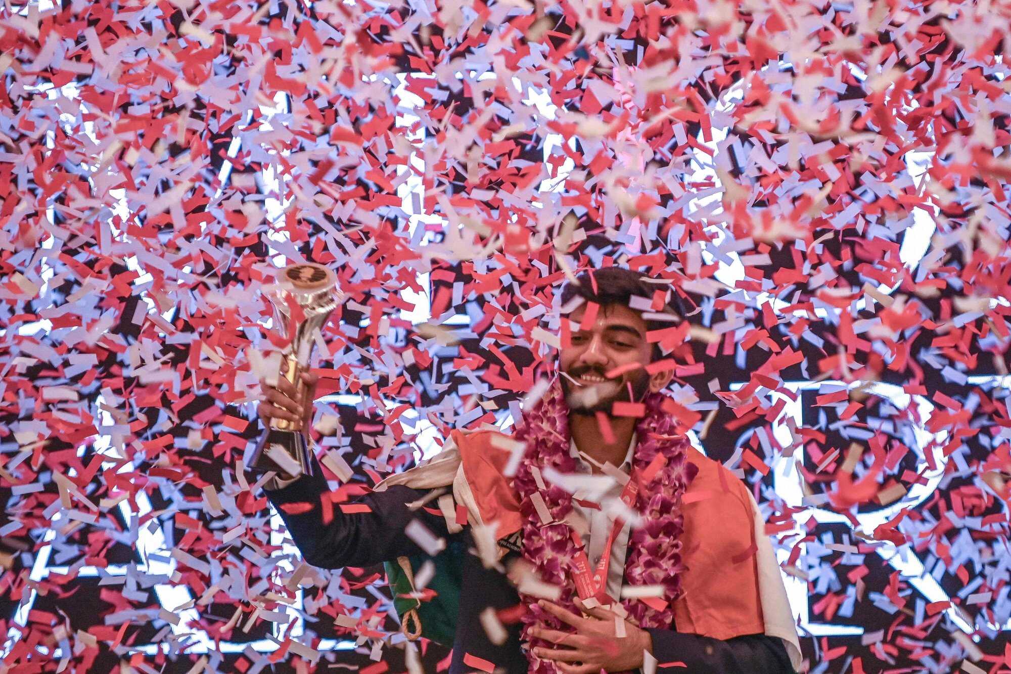 Gukesh Dommaraju celebrates with his World Chess Championship 2024 trophy during an award ceremony in Singapore. Photo: AFP