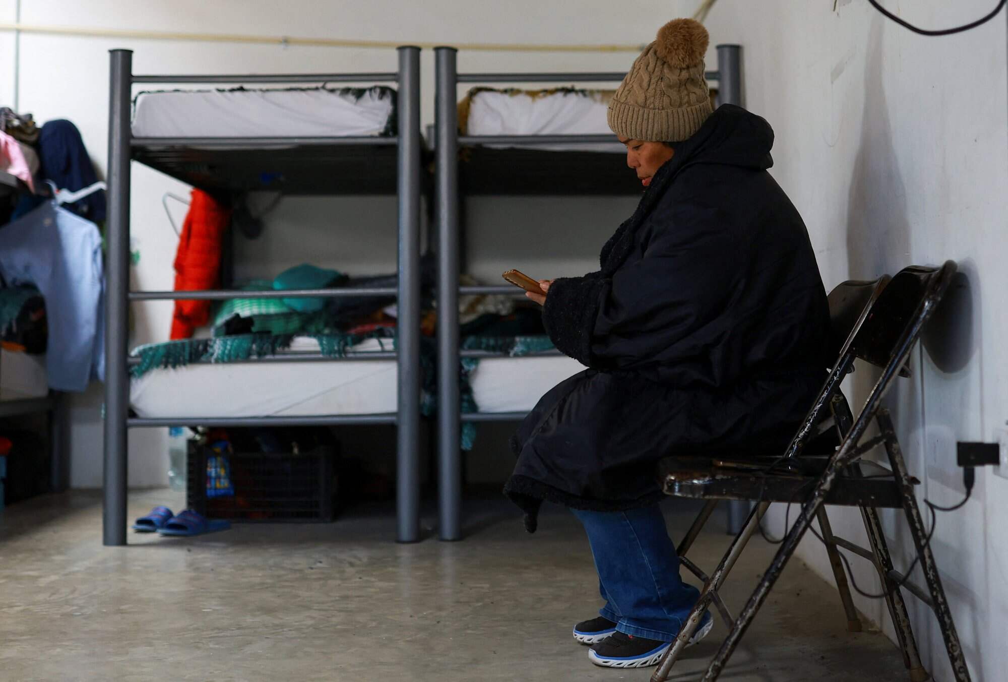 Margelis Tinoco, a Colombian migrant whose US Customs and Border Protection CBP One appointment was cancelled, looks at her mobile phone at the El Buen Samaritano shelter, in Ciudad Juarez, Mexico on January 26, 2025. Photo: Reuters