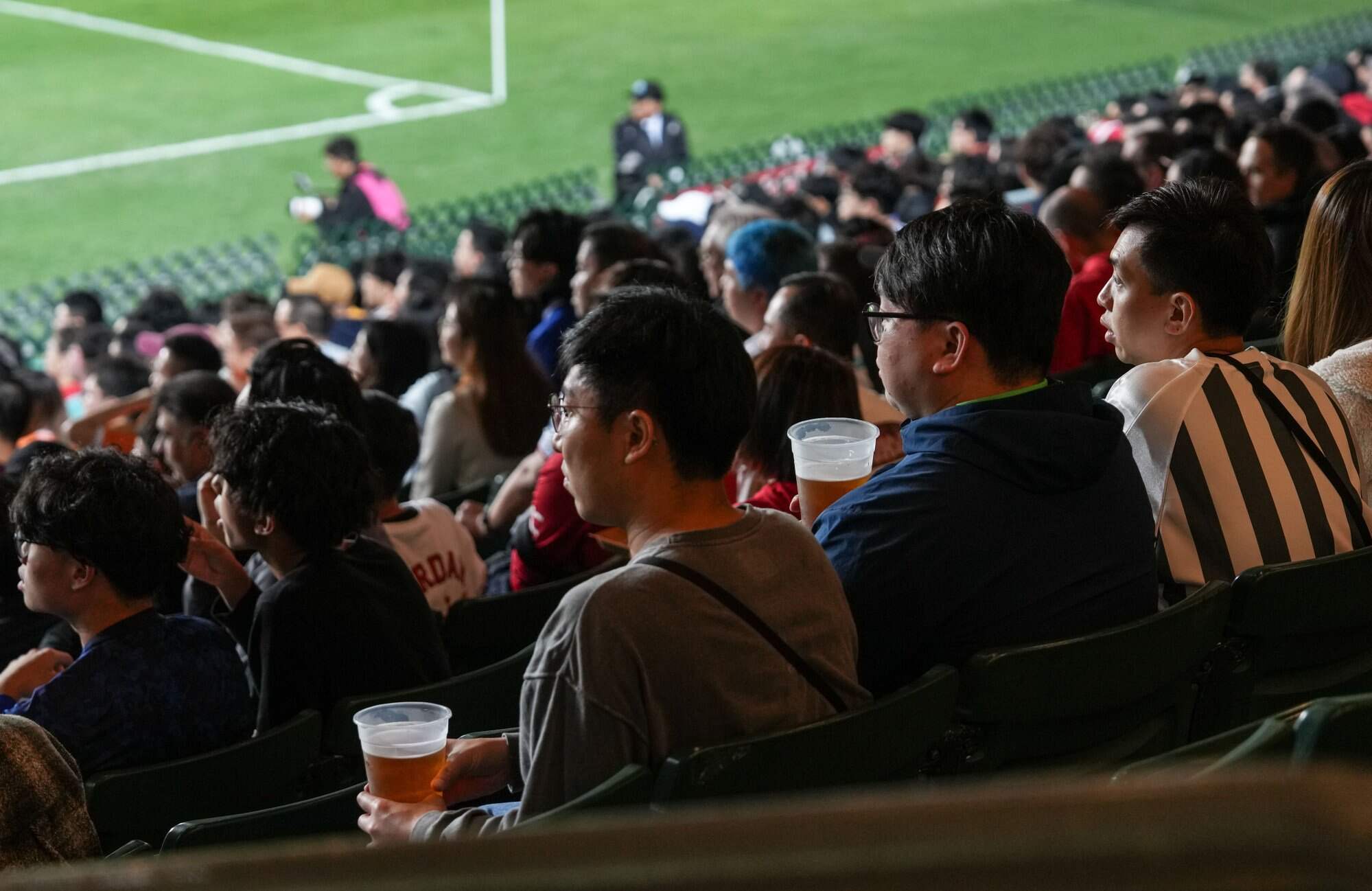 To estimate the amount of waste the new sports park’s main stadium would generate, a Greenpeace team and volunteers attended the Chinese New Year Cup at Hong Kong Stadium on February 1. Photo: Greenpeace