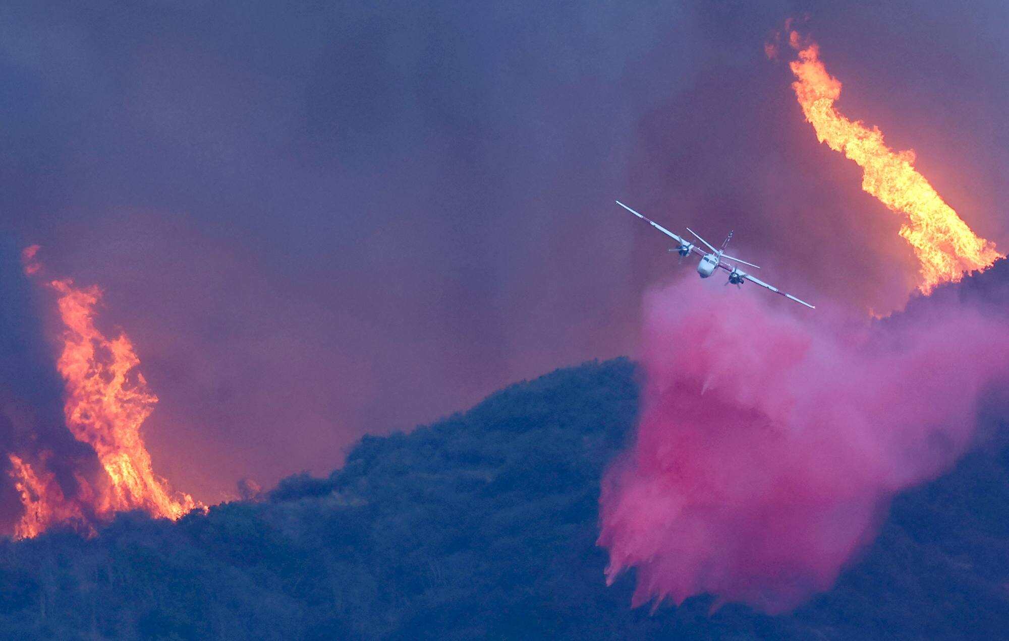 A firefighting aircraft drops the fire retardant Phos-Chek on the Palisades Fire on January 7, 2025 in Pacific Palisades, California. Photo: Mario Tama/Getty Images/AFP