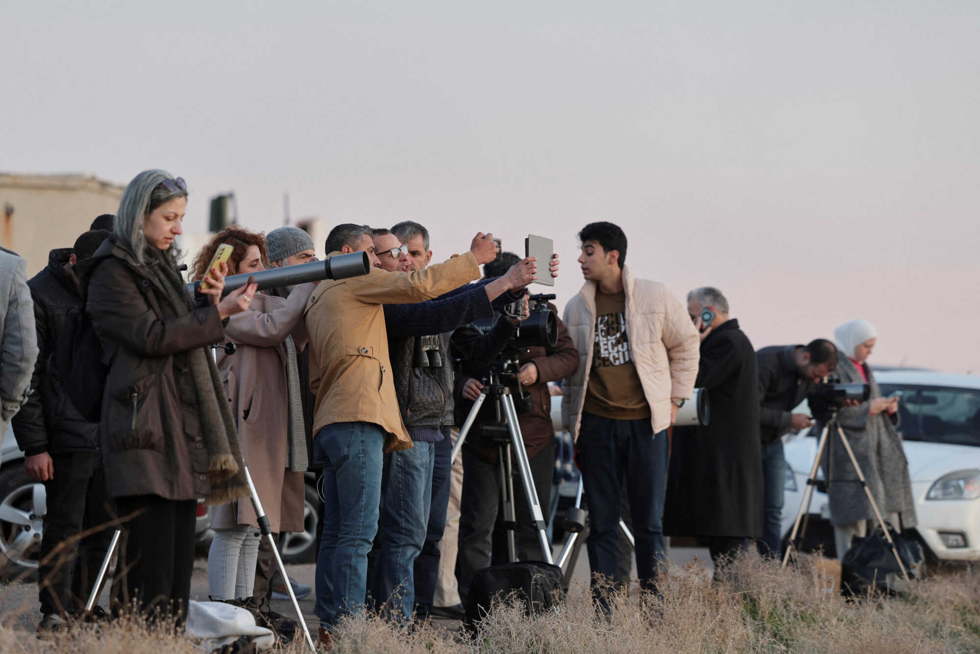 People use telescopes to look for the position of the moon to determine the start of Ramadan, at Mount Qasioun in Damascus, Syria. Photo: Reuters