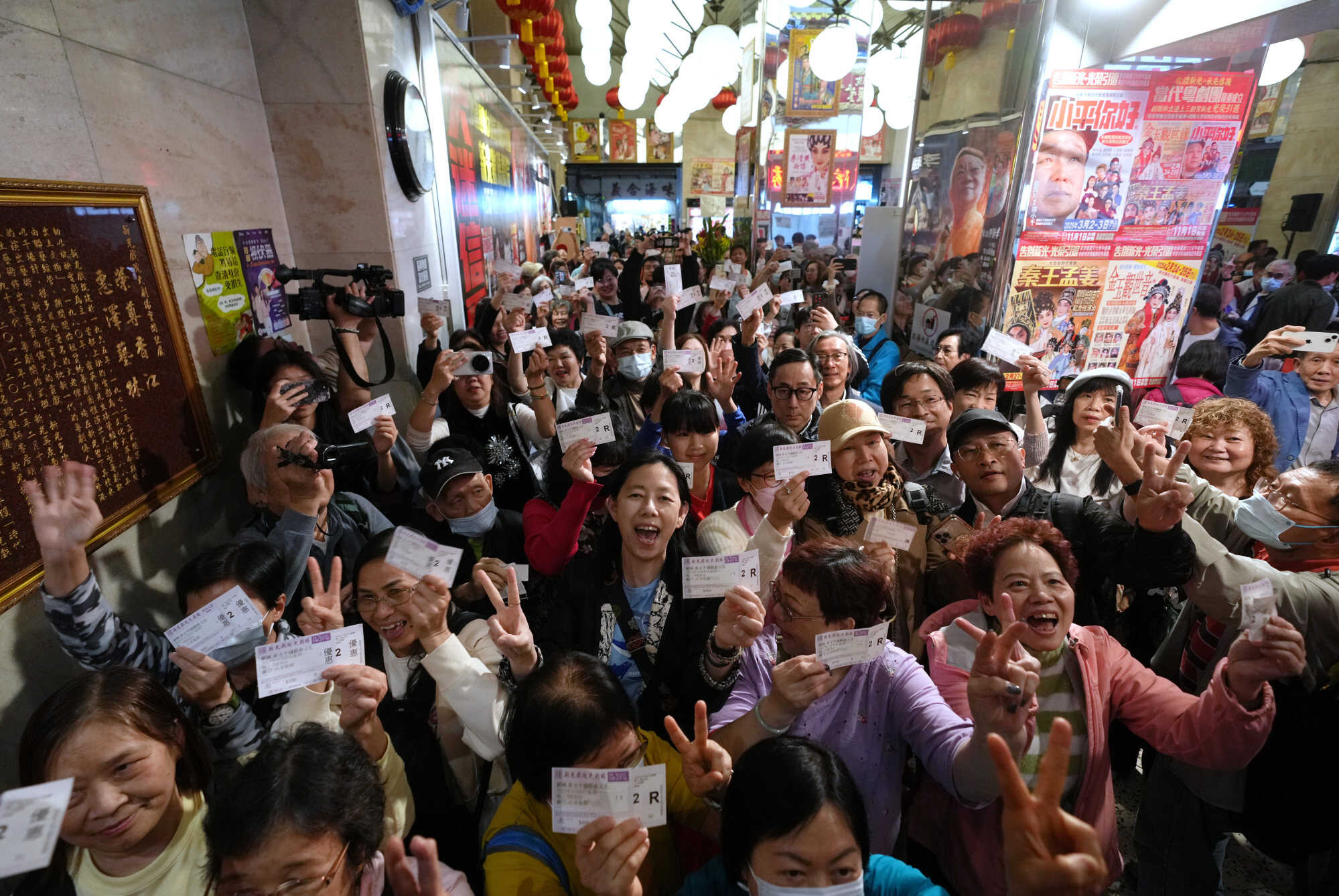 Residents hold up tickets for the final show. Photo: Sam Tsang