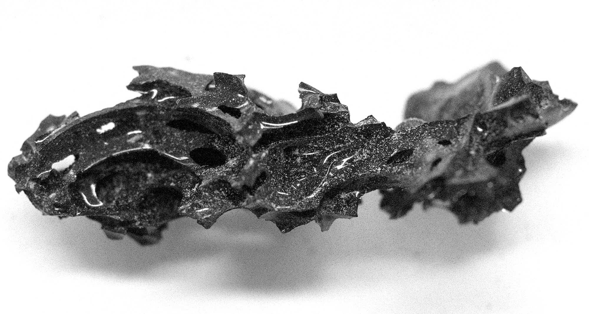 A fragment of the organic glass found inside the skull of the deceased individual at the archaeological site of Herculaneum in Italy. Photo: Pier Paolo Petrone via Reuters