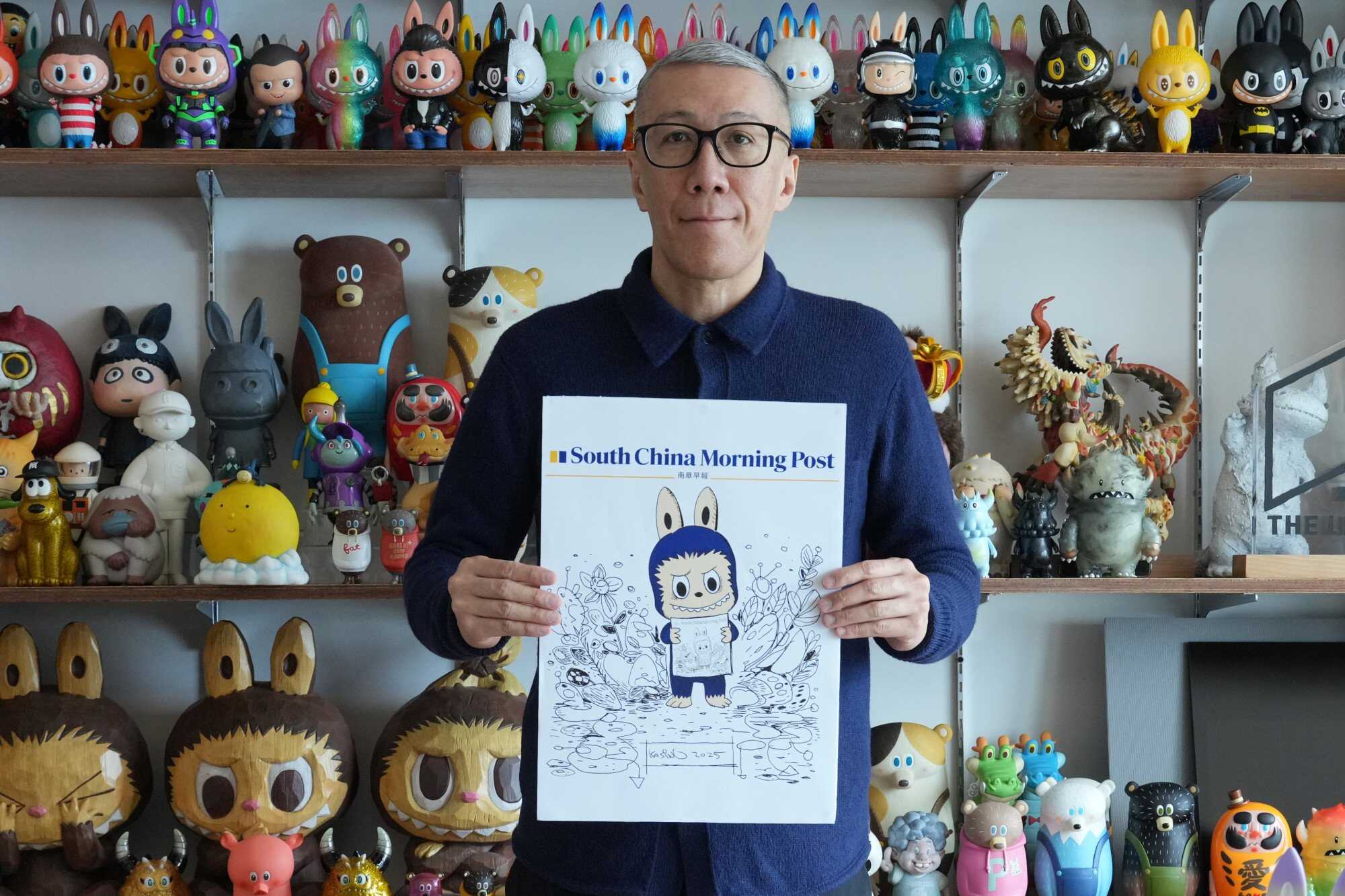 Hong Kong artist Kasing Lung at his studio in Kwun Tong holding an illustration for SCMP. Lung is the creator of the popular Labubu character, a perpetually sold-out doll and blind box toy at Pop Mart. Photo: May Tse