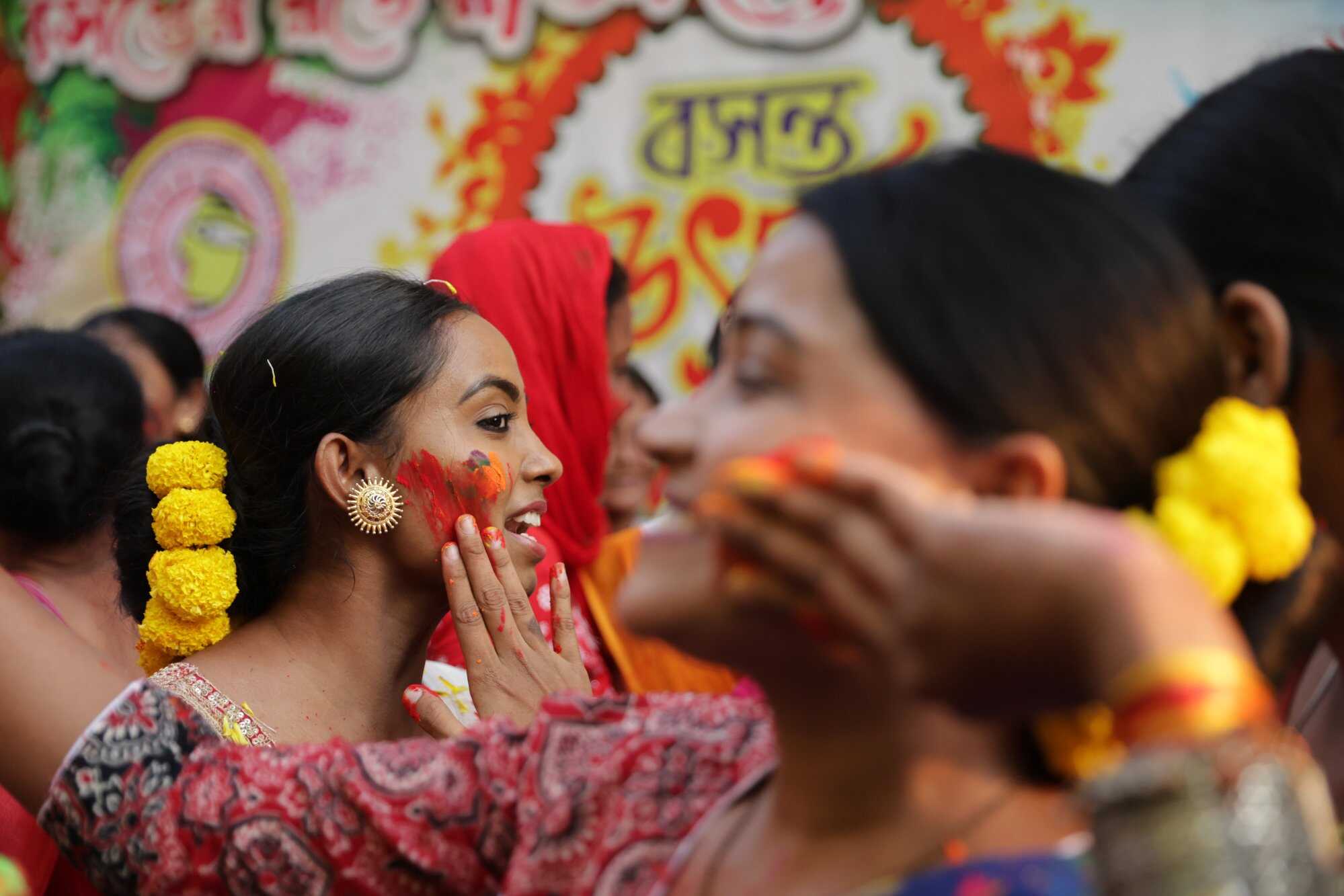 People celebrate Holi by applying gulal (colour) on each other at a local market in Kolkata, eastern India. Photo: EPA-EFE