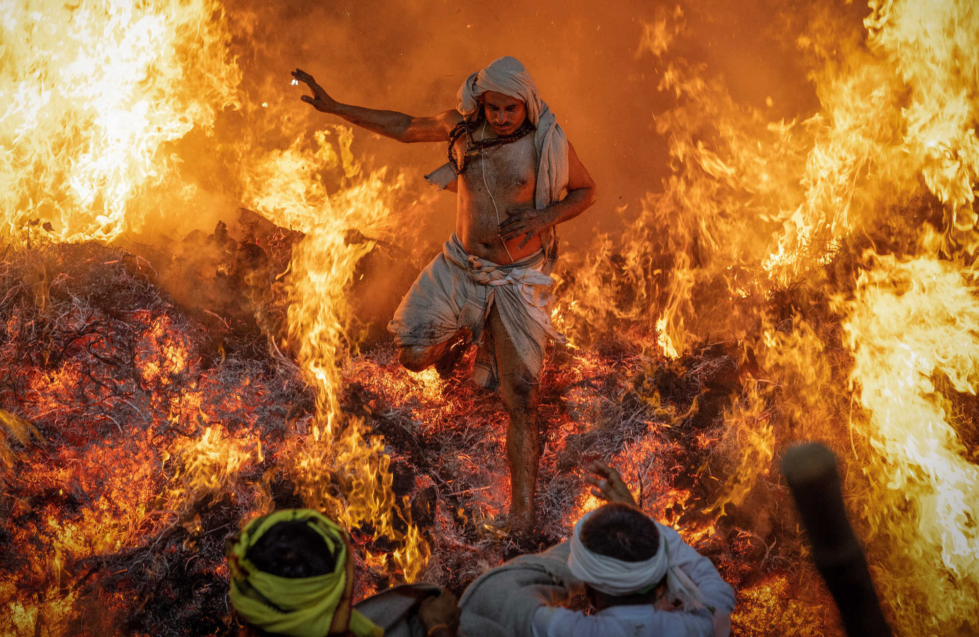 Sanju, a Hindu priest, jumps out of a fire during “Holika Dahan”, part of the Holi festival celebrations at the Phalen village near the northern Indian city of Mathura in Uttar Pradesh, India. Photo: Reuters