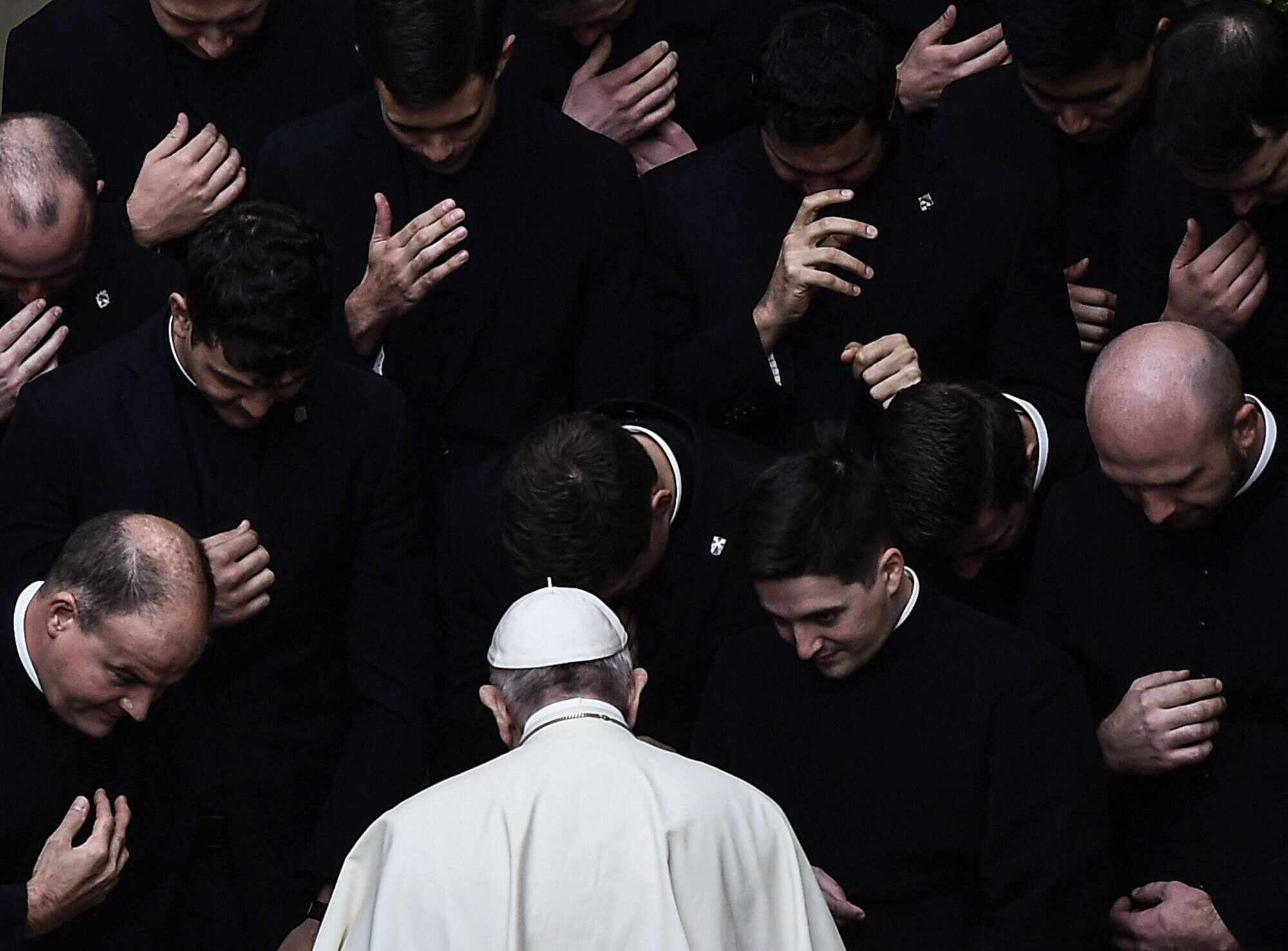 Pope Francis prays with priests at the end of a limited public audience at the San Damaso courtyard in The Vatican in September 2020. Photo: AFP