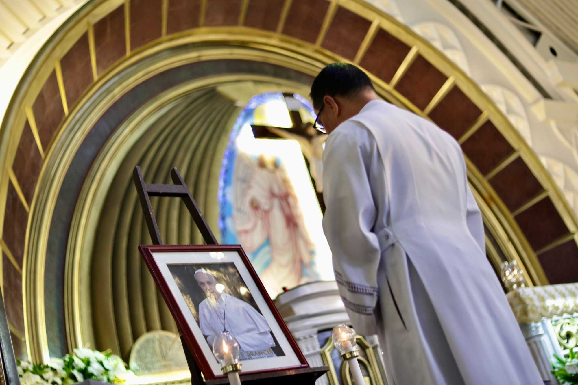 Filipino priest Jason Bill Valeza places a picture of Pope Francis on the altar at Christ the King Church in Las Piñas City, Metro Manila, Philippines. Photo: EPA-EFE