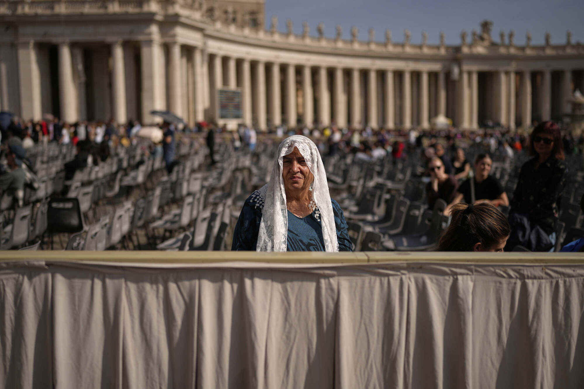 A woman sits in St Peter’s Square as people wait to pay their respects to the late Pope Francis. Photo: AP