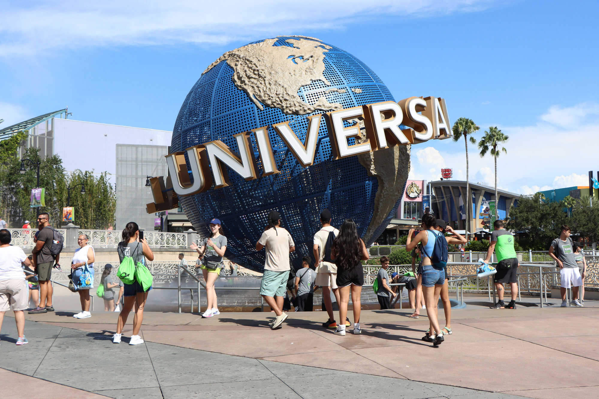 Tourists take photos at the globe outside the entrance to Universal Studios Florida in Orlando, Florida, United States. Photo: TNS