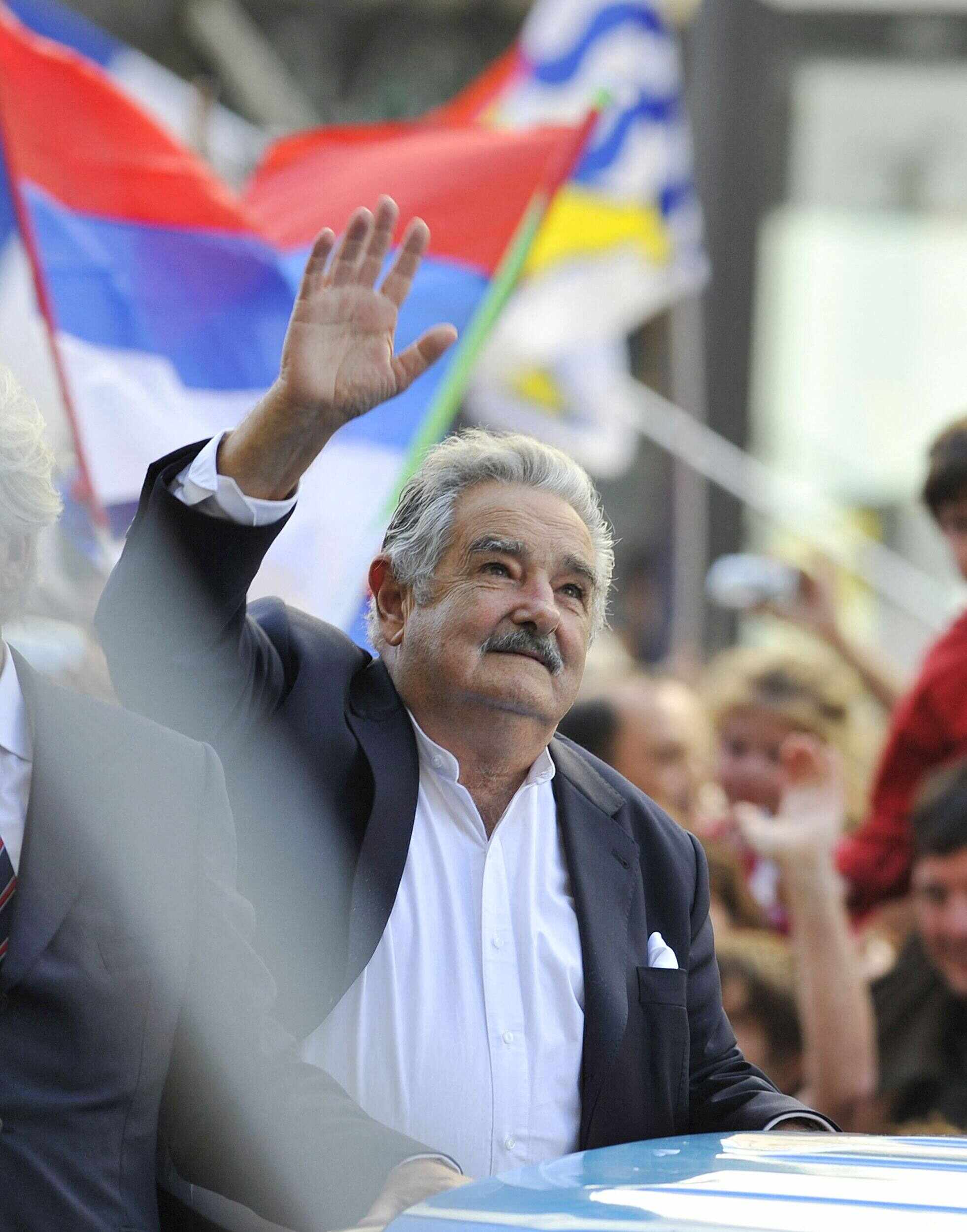 Newly sworn-in Uruguayan president Jose Mujica waves to the crowd in the streets of Montevideo on the day of his inauguration on March 1, 2010. Photo: AFP
