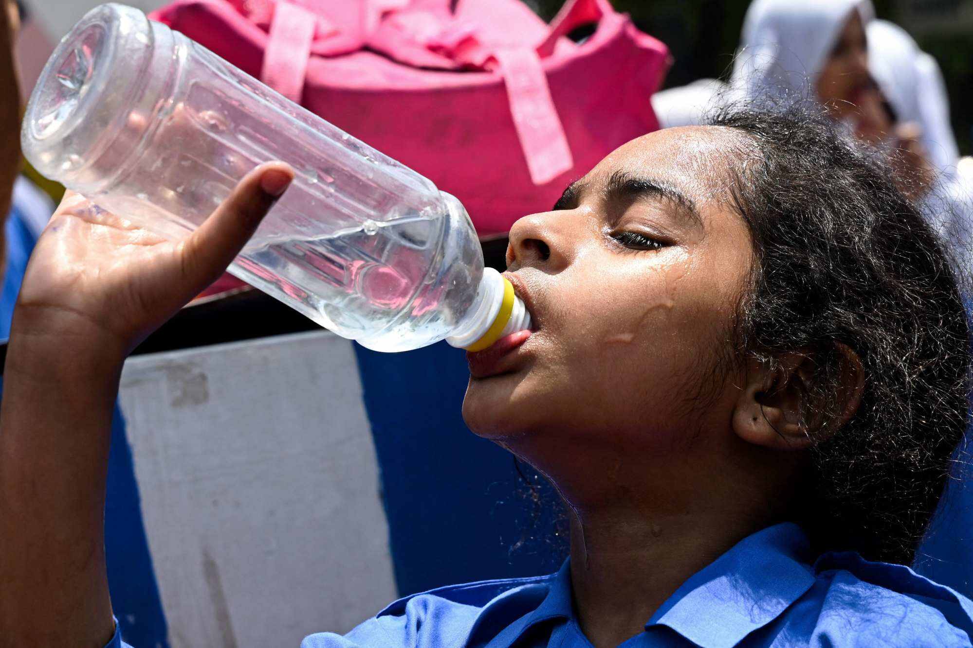 A girl drinks water after her classes on a hot summer day in Lahore as the state government announced early summer holidays for schools owing to rising temperatures. Photo: AFP