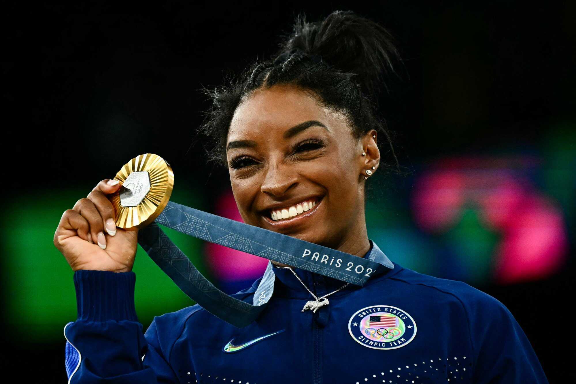 Simone Biles poses with her gold medal during the podium ceremony after the artistic gymnastics women’s all around final during the Paris 2024 Olympic Games on August 1, 2024. Photo: AFP/Getty Images/TNS