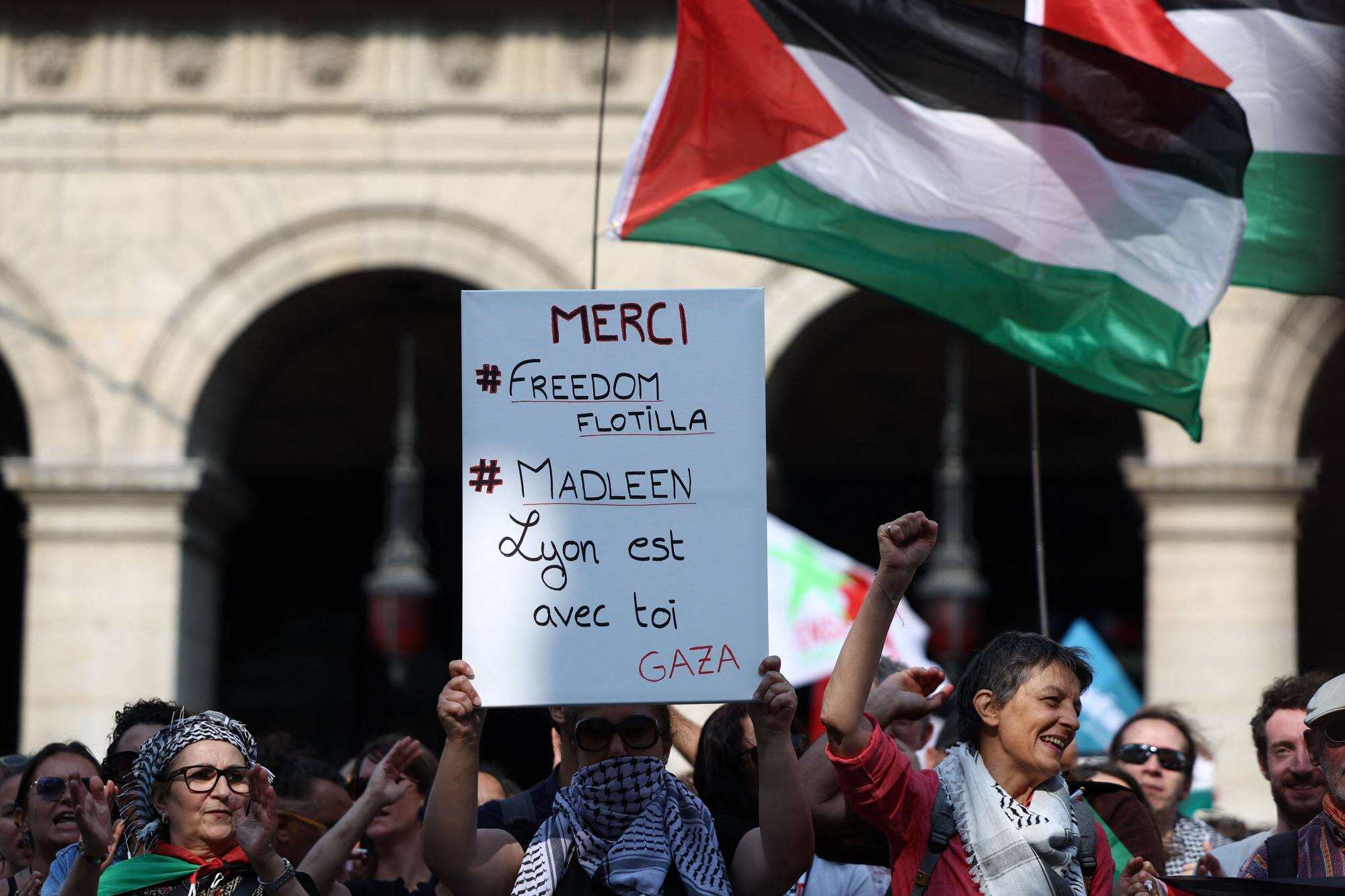 A placard reads “Thank you freedom flotilla, Lyon is with you Gaza” in Lyon, France. Participants rallied to show their support for activists aboard a boat stopped by Israeli forces enroute to deliver aid to Gaza. Photo: AFP